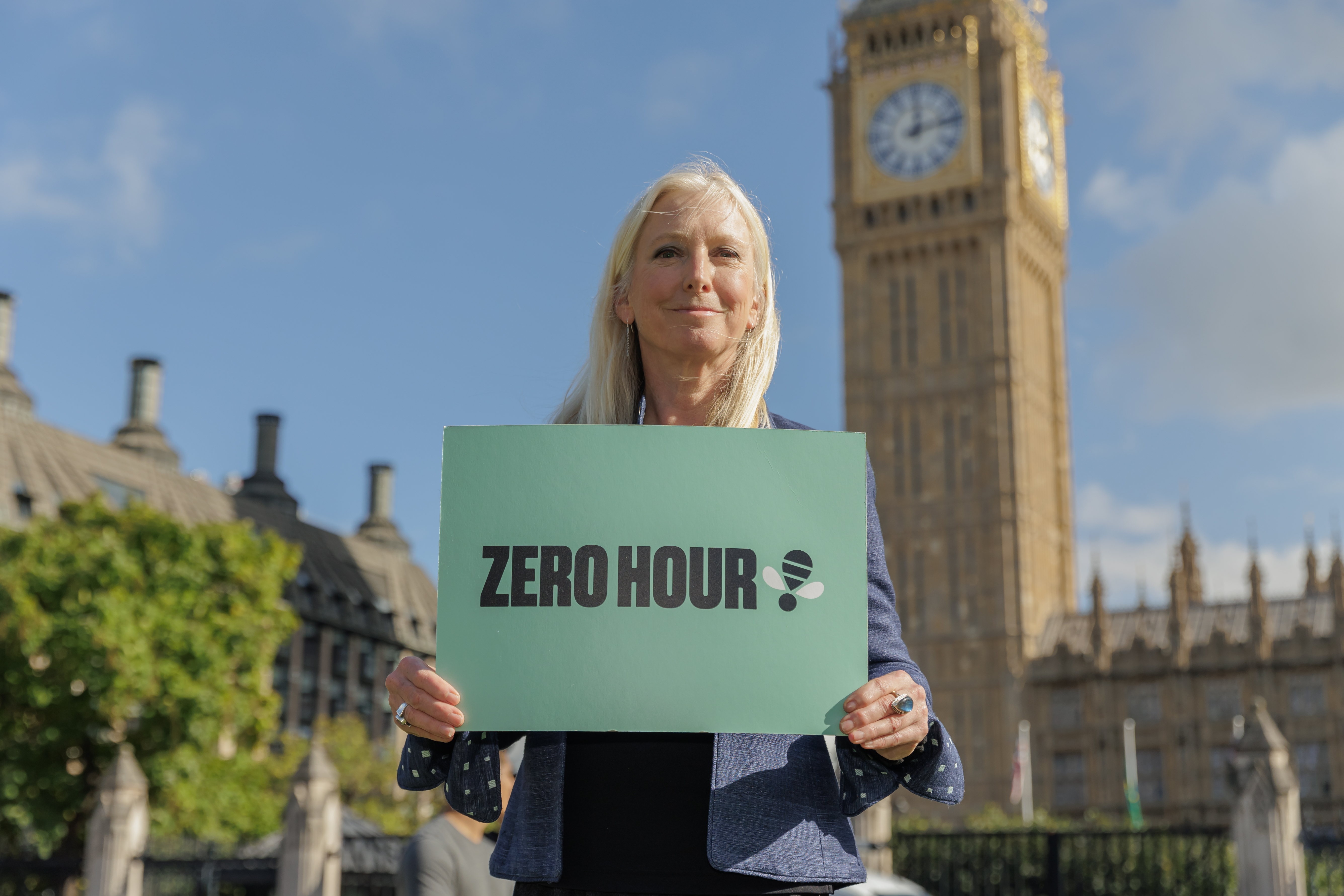 Roz Savage holds a 'Zero Hours' campaign placard