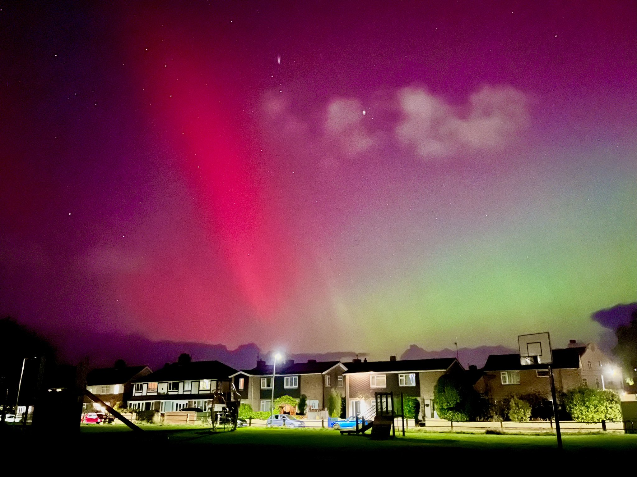 Bright pink and faint green hues of the Northern Lights light up the skies over Cromer, Norfolk