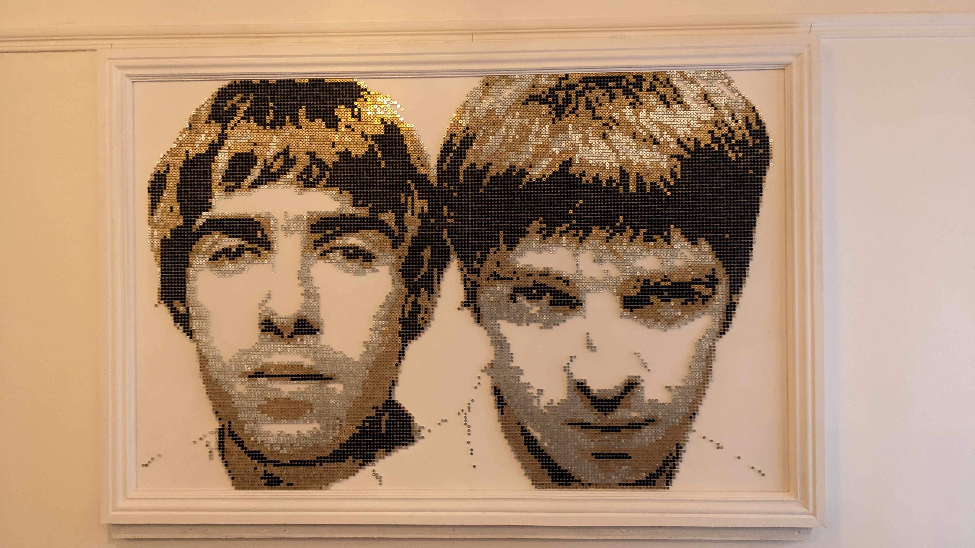 An artwork using screws showing the Gallagher brothers from Oasis 