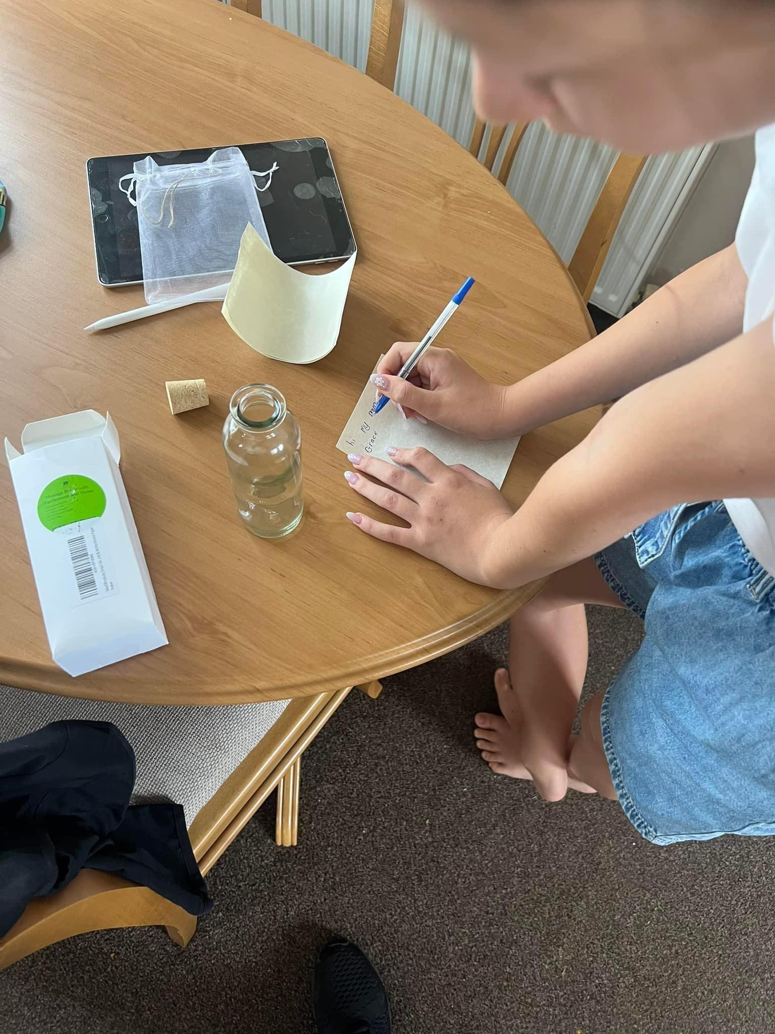 Girl writing message on paper 