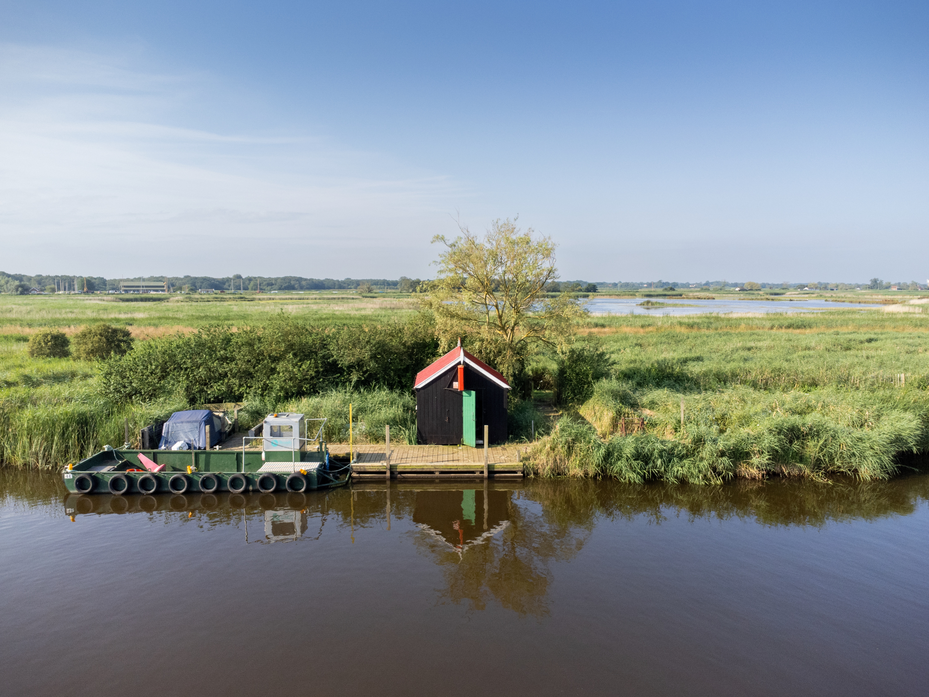 The Eel Sett building near a river in the Norfolk Broads 