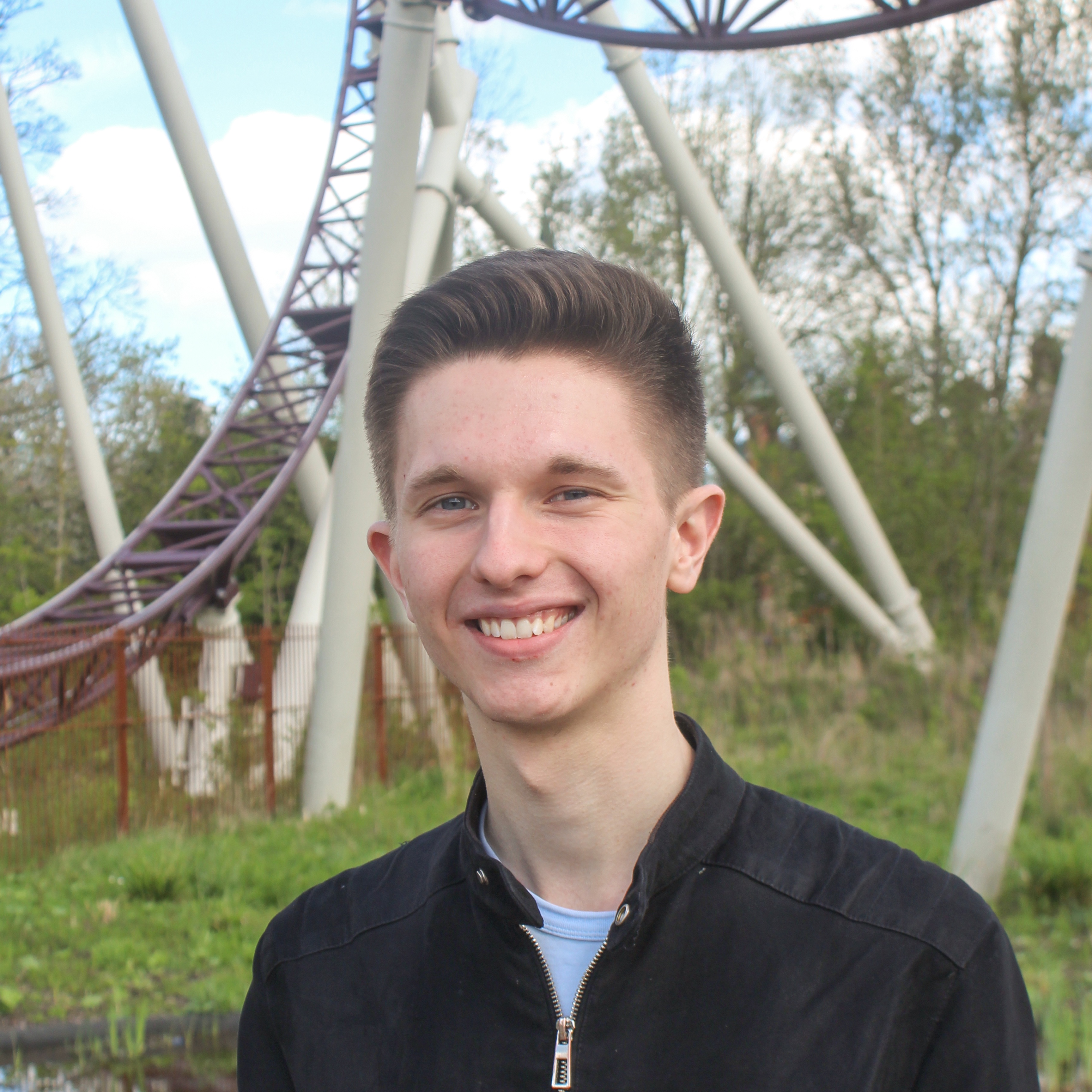 A man in front of a ferris wheel