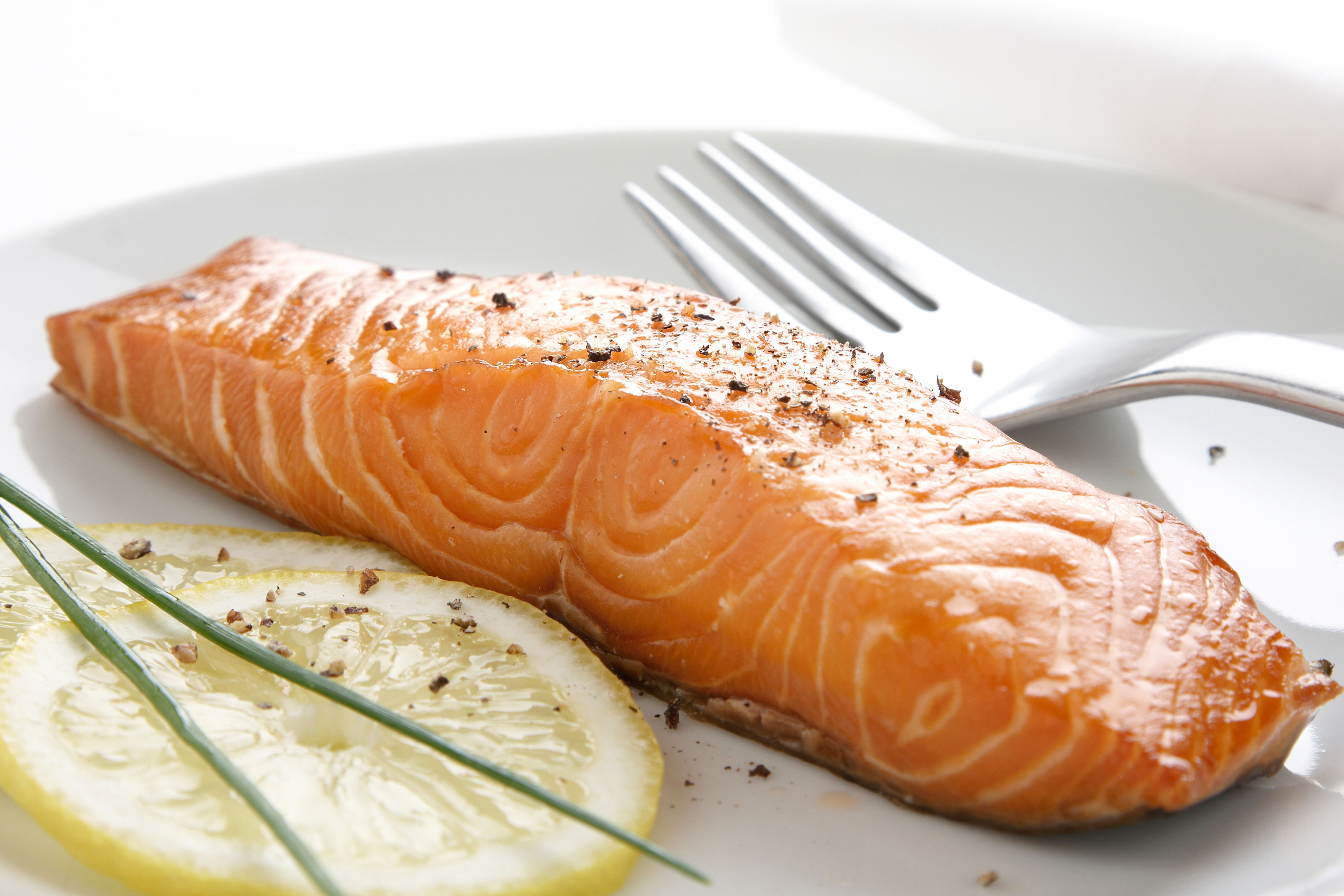 Grilled salmon with a slice of lemon on a plate 