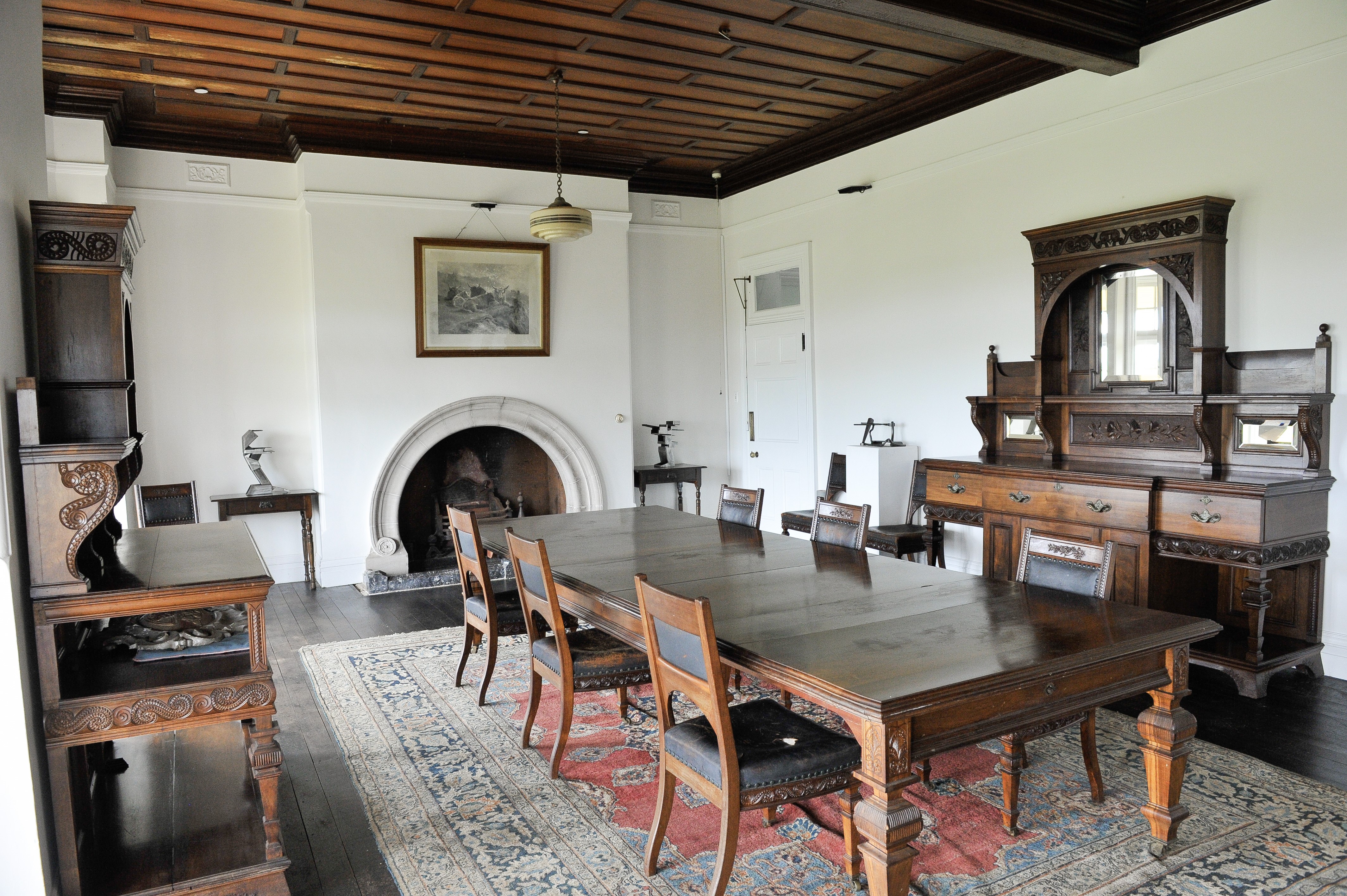 Wooden dining table and chairs inside the former summer residence of the Governor of New South Wales 