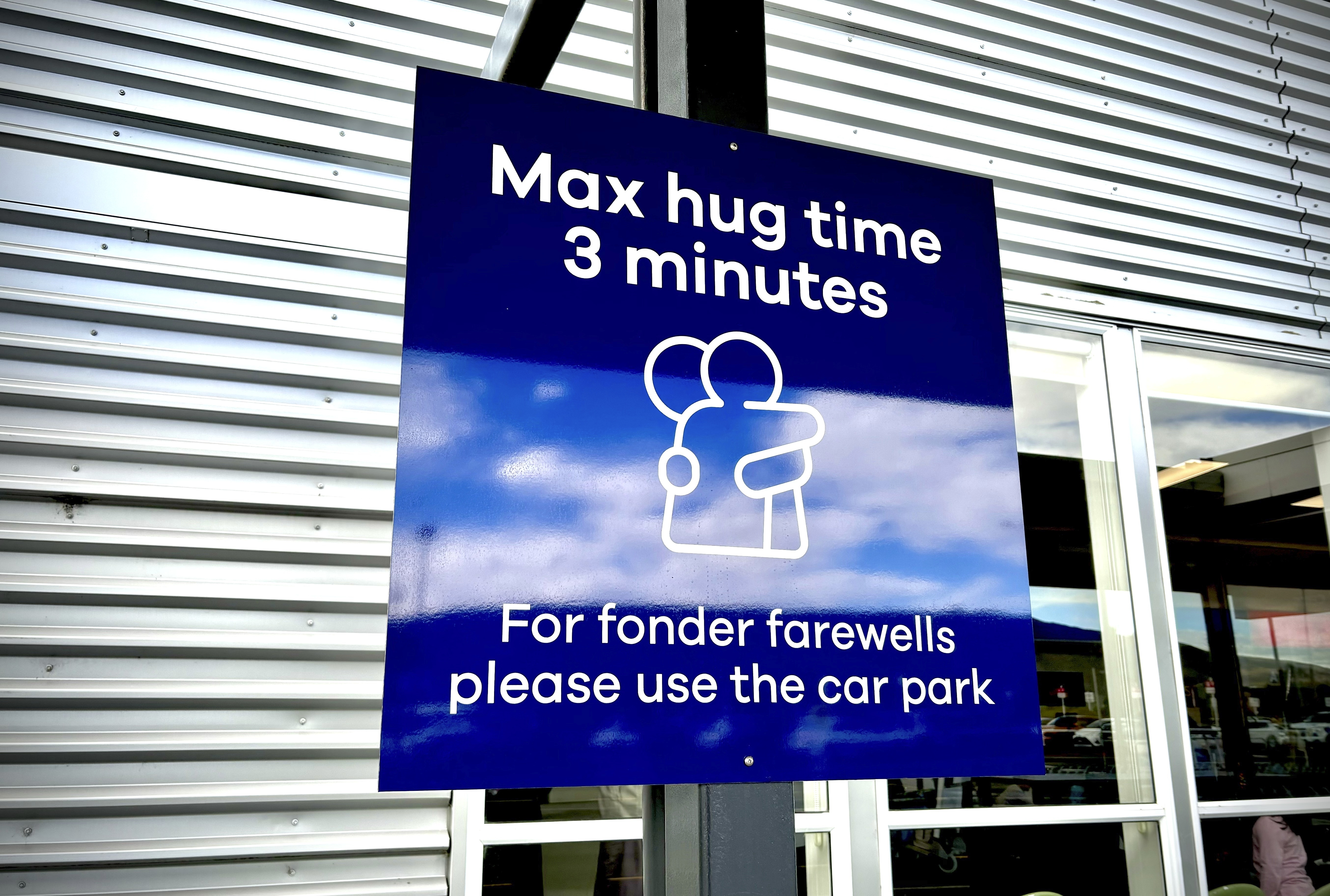 A sign advising three minute hug limits