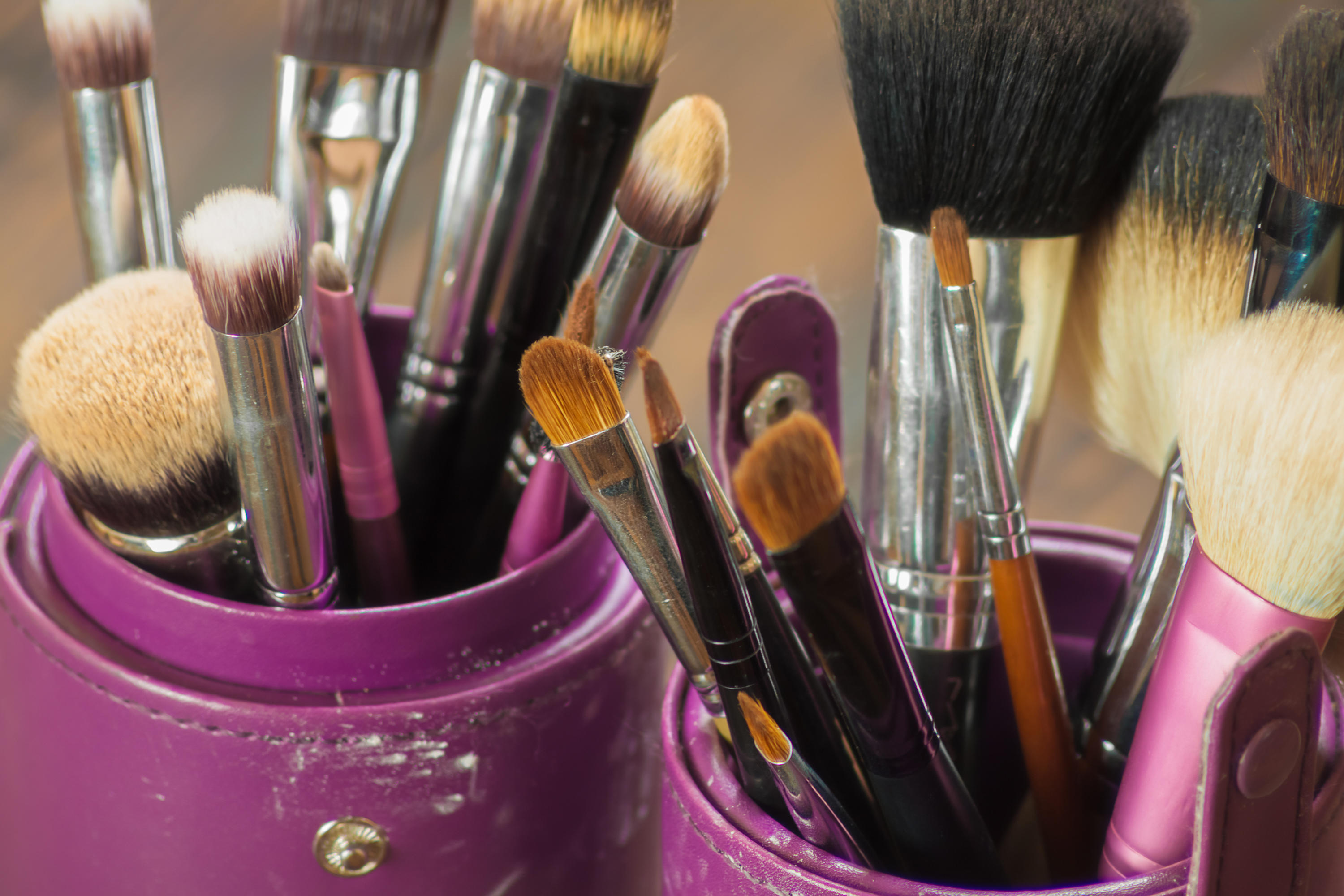 Dirty make-up brushes sit in a pot