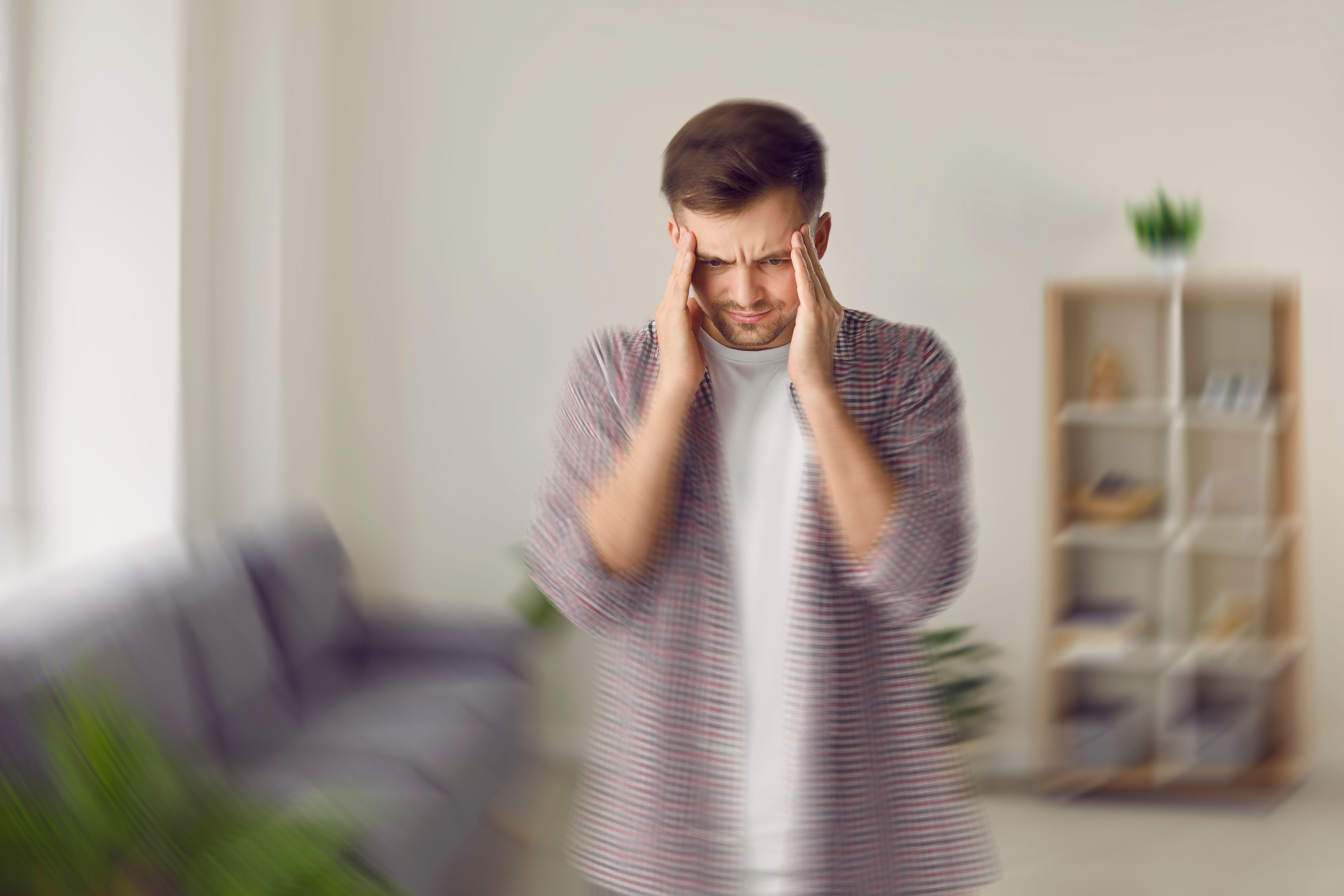 A young man experiencing vertigo