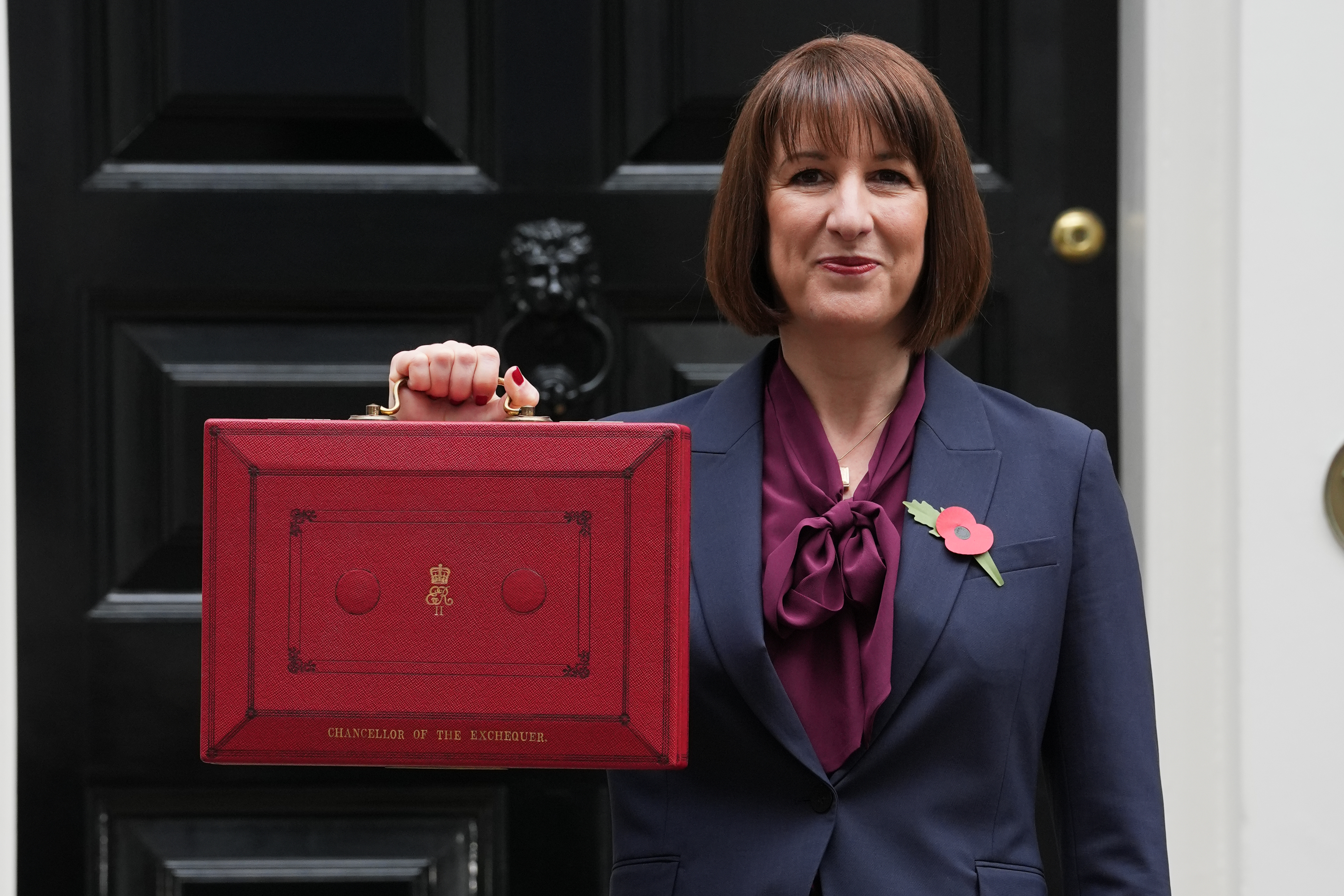 Rachel Reeves smiling while holding up her ministerial red box