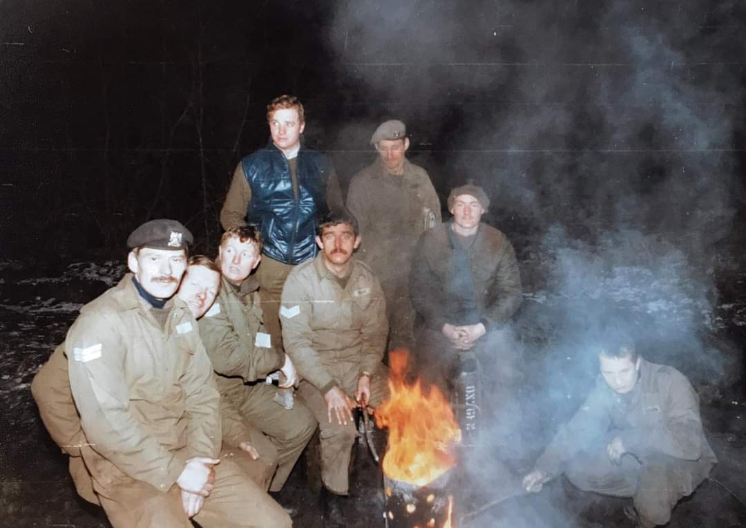 Group of soldiers sat around a fire