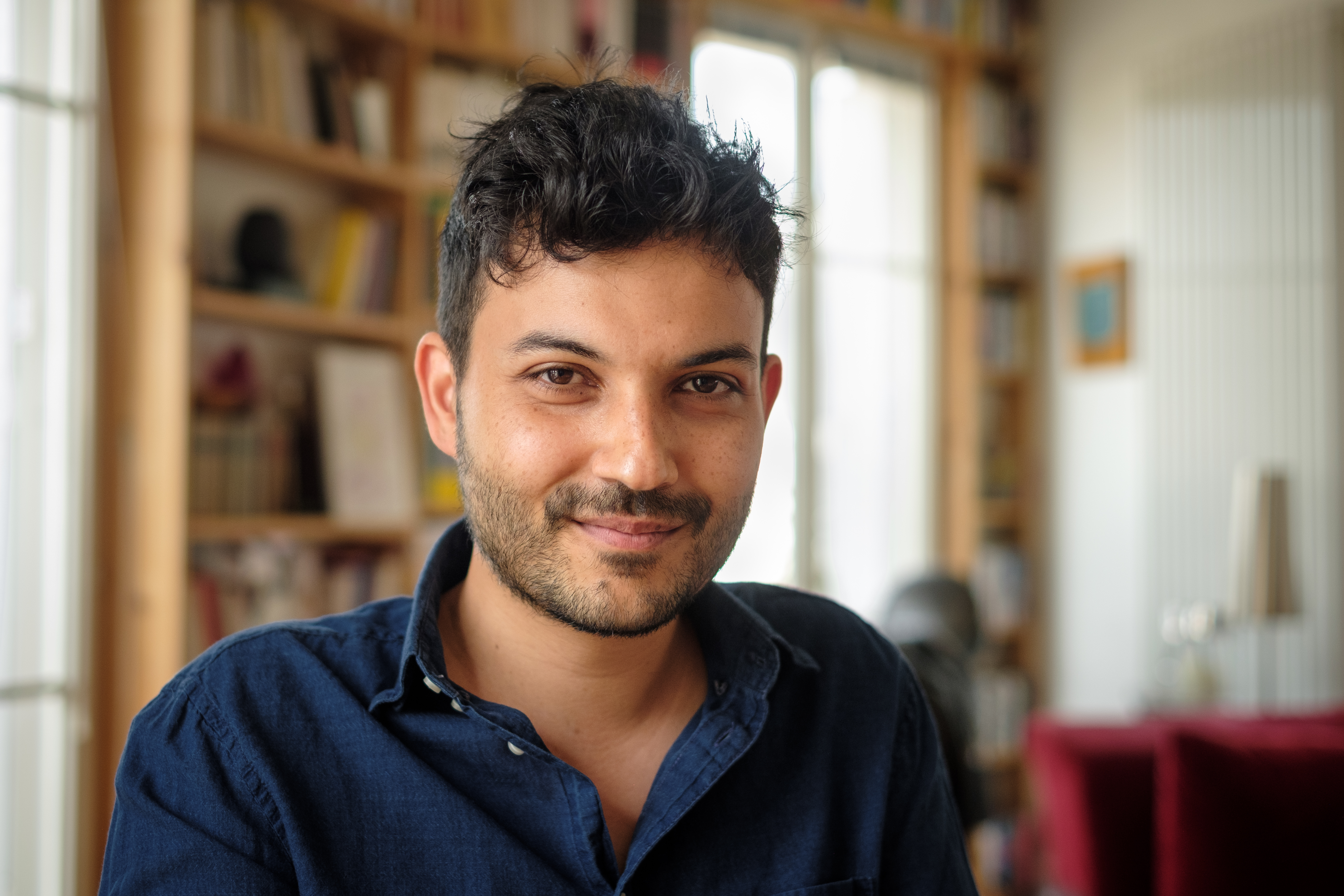 Ferdia Lennon wearing a dark blue, open-collared shirt