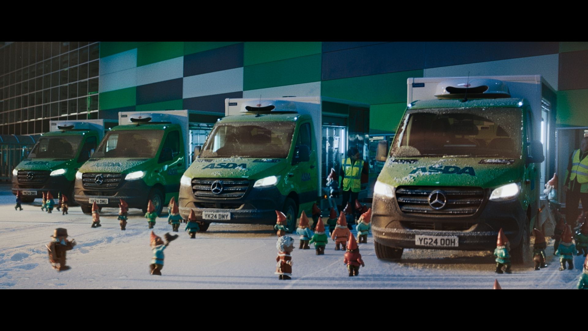 A still photo from this year's Christmas Asda ad featuring dozens of gnomes walking among Asda vans in the snow