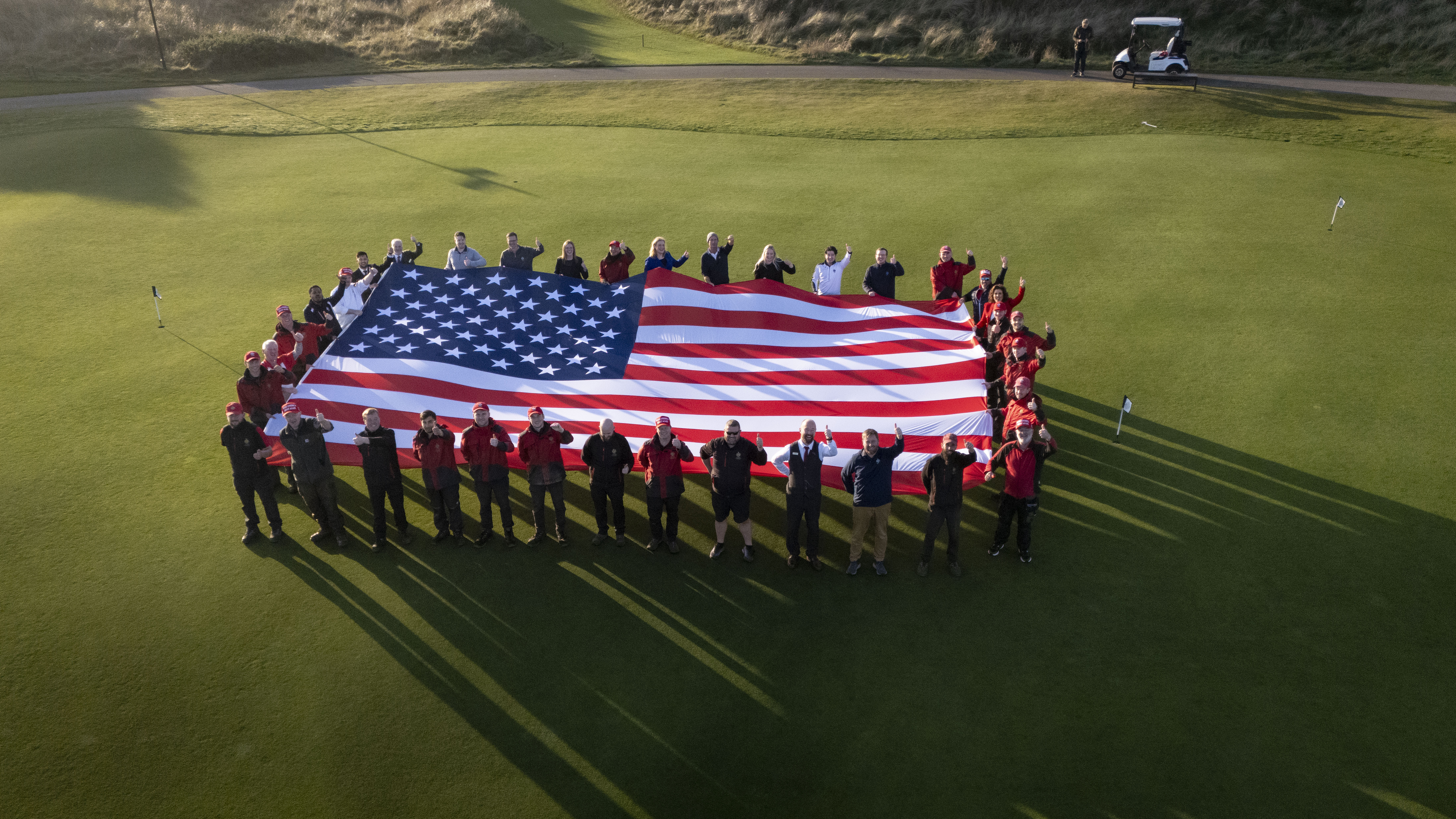 Trump International Scotland staff hold American flag in celebration of Donald Trump's election victory