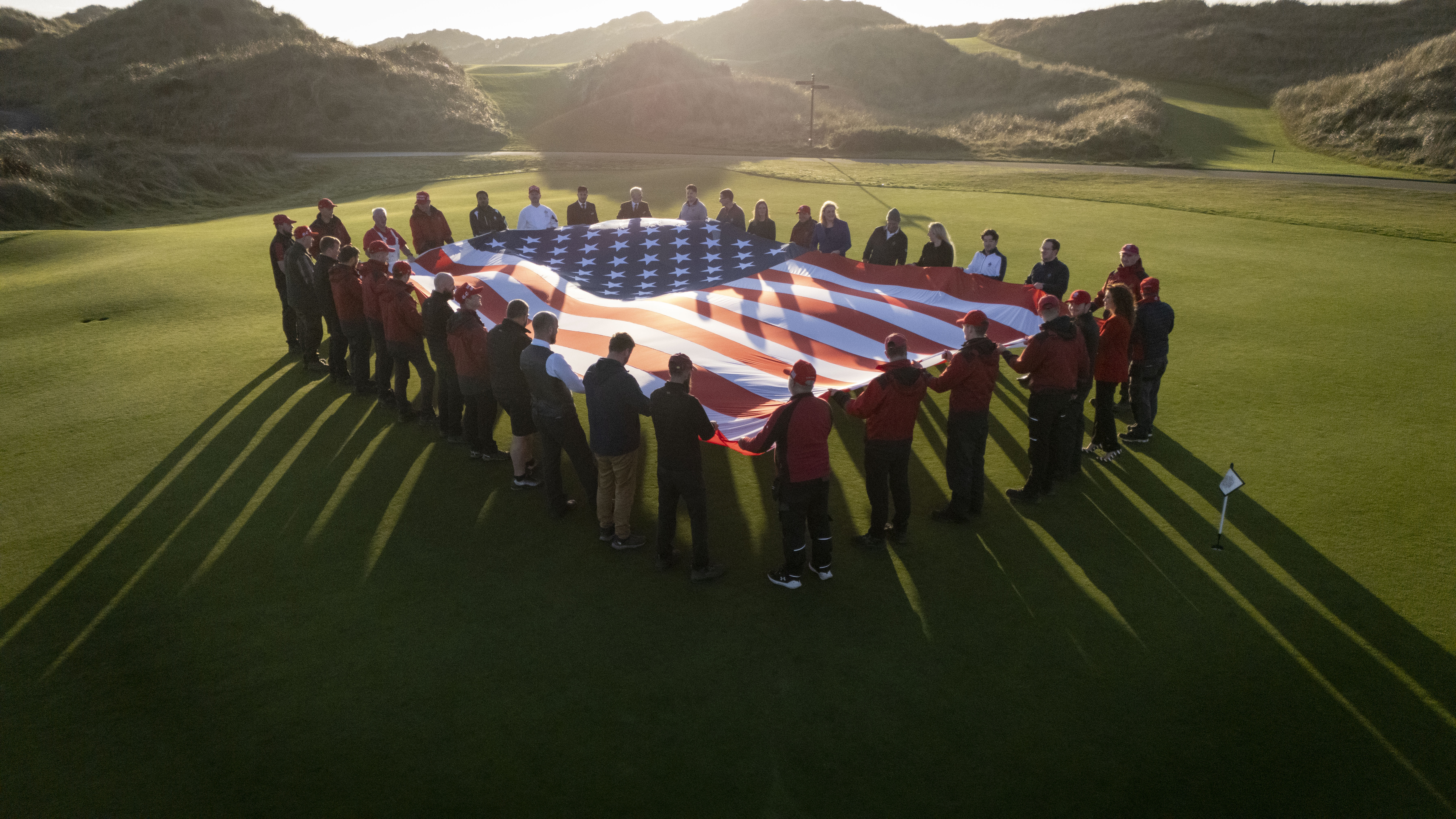 Trump International Scotland staff hold American flag in celebration of Donald Trump's election victory