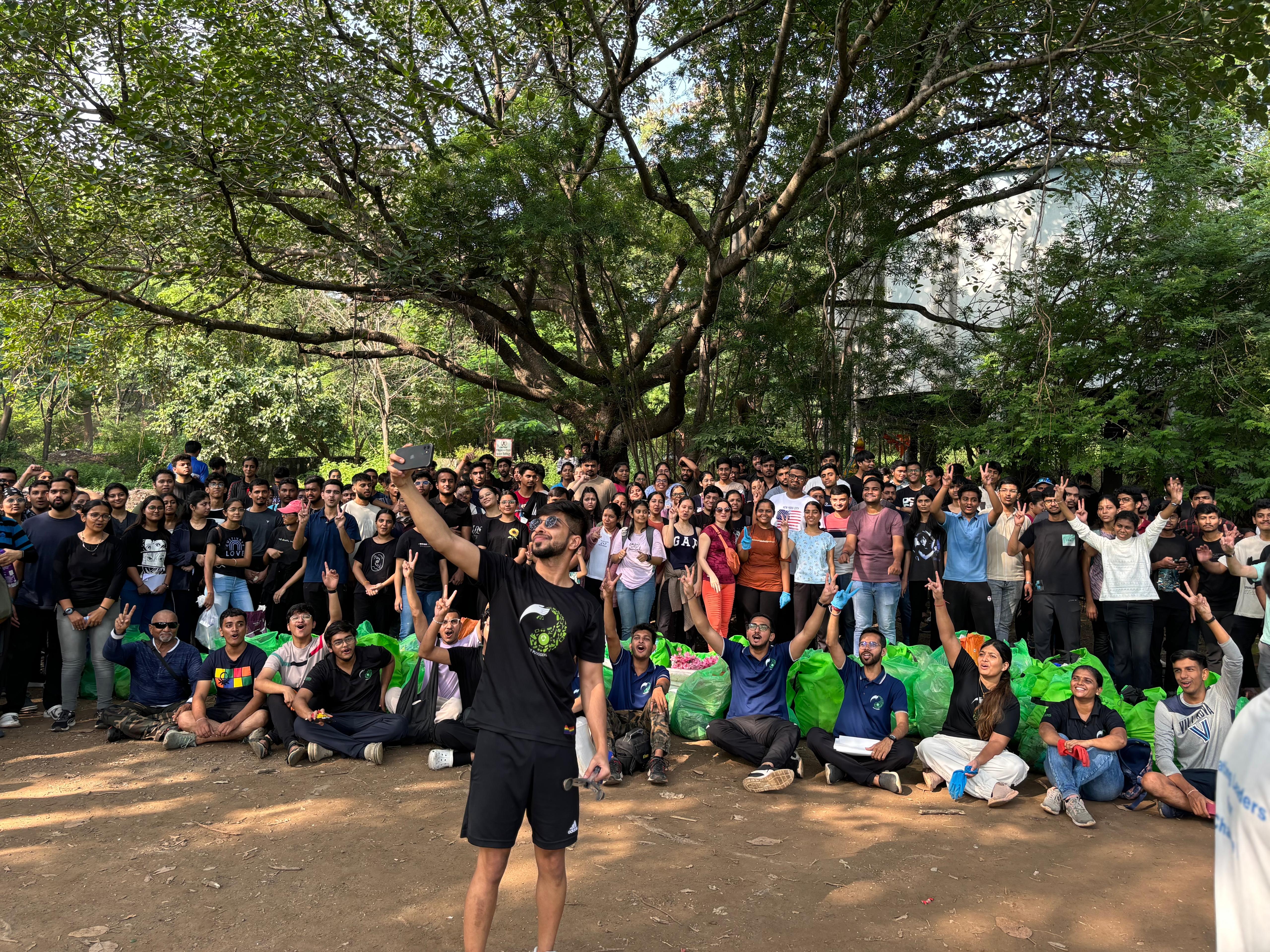 A man taking a photo with a crowd of people