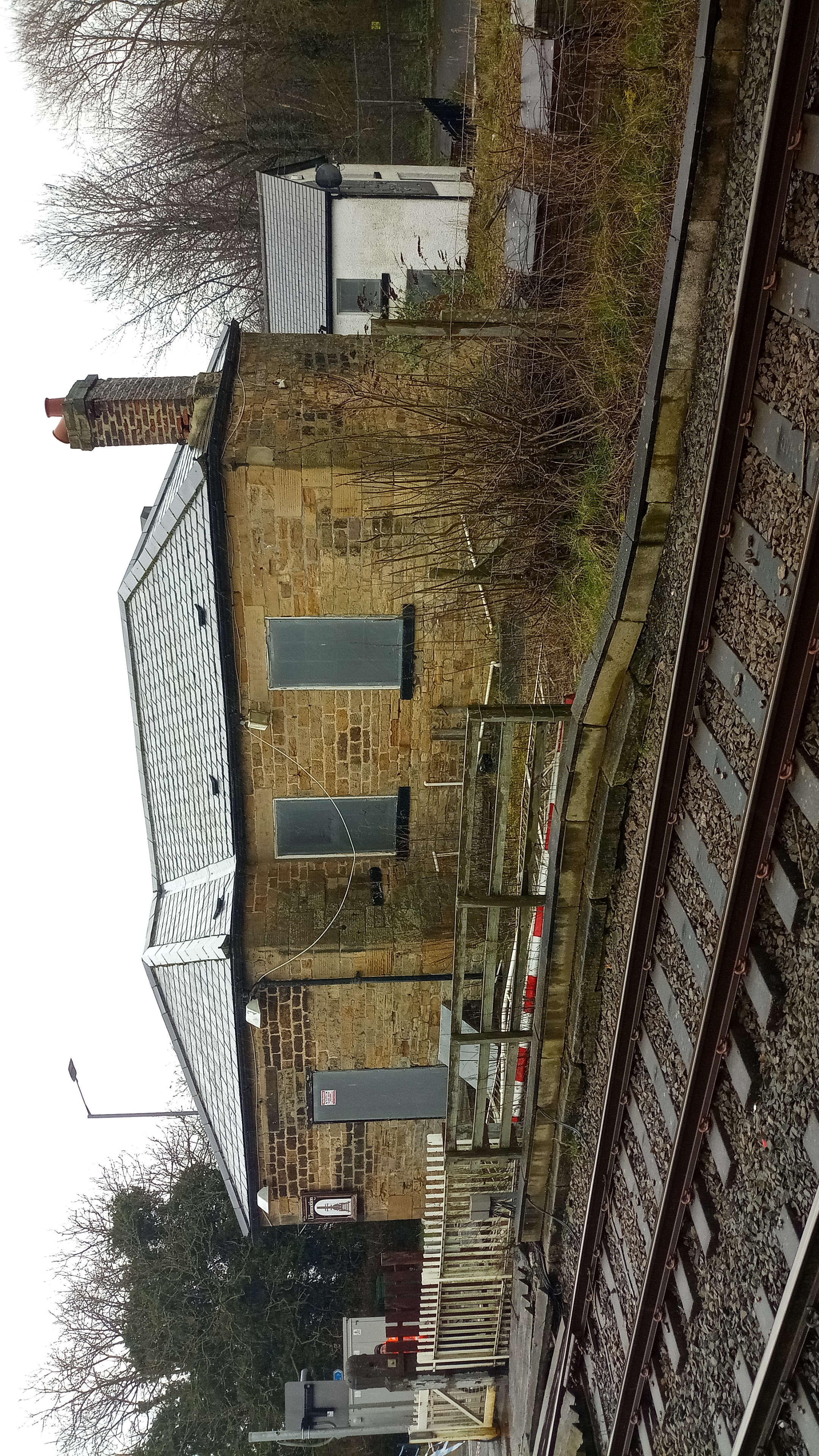 Heighington and Aycliffe Railway Station, with boarded up windows by the railway track