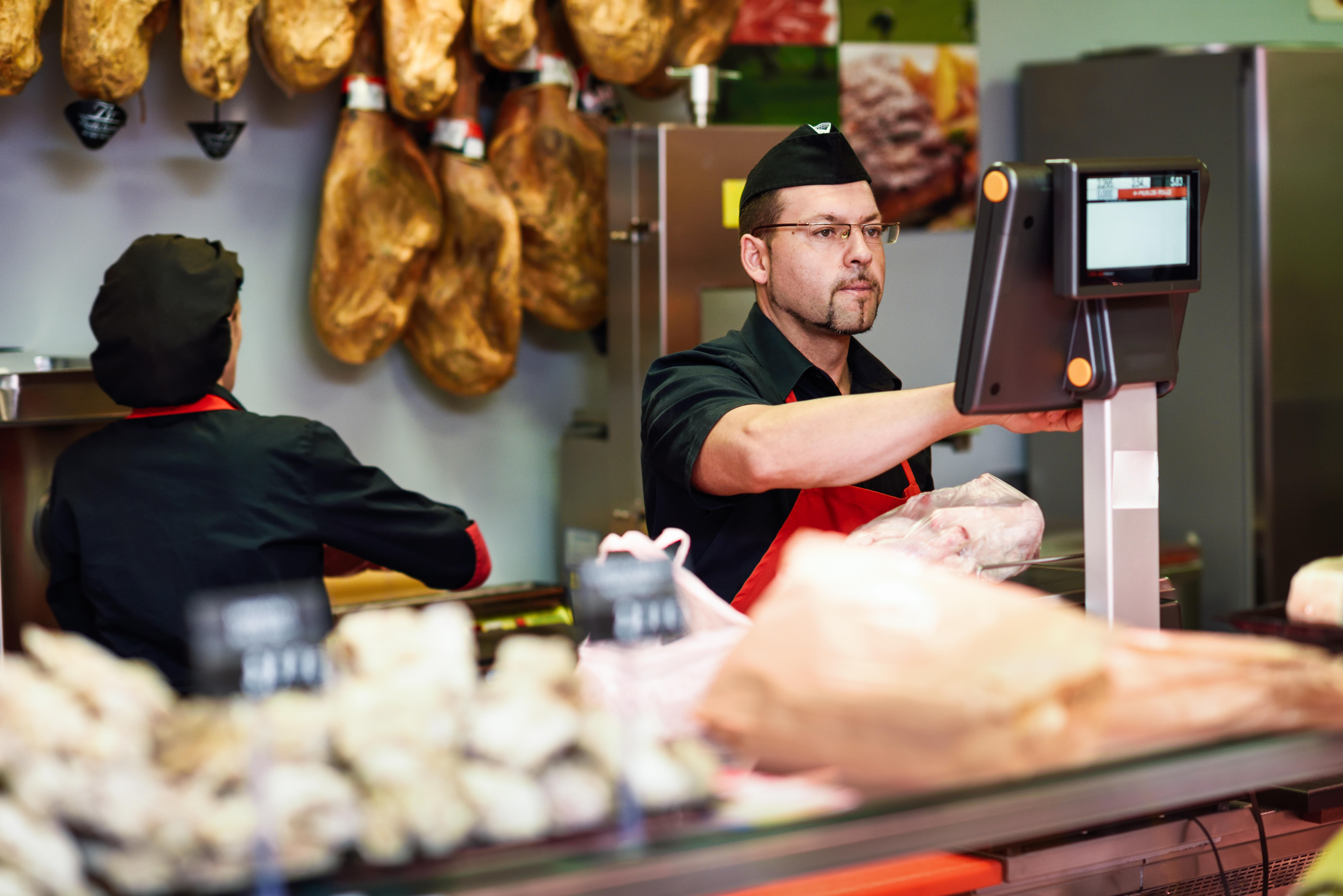 A butcher at a meat counter