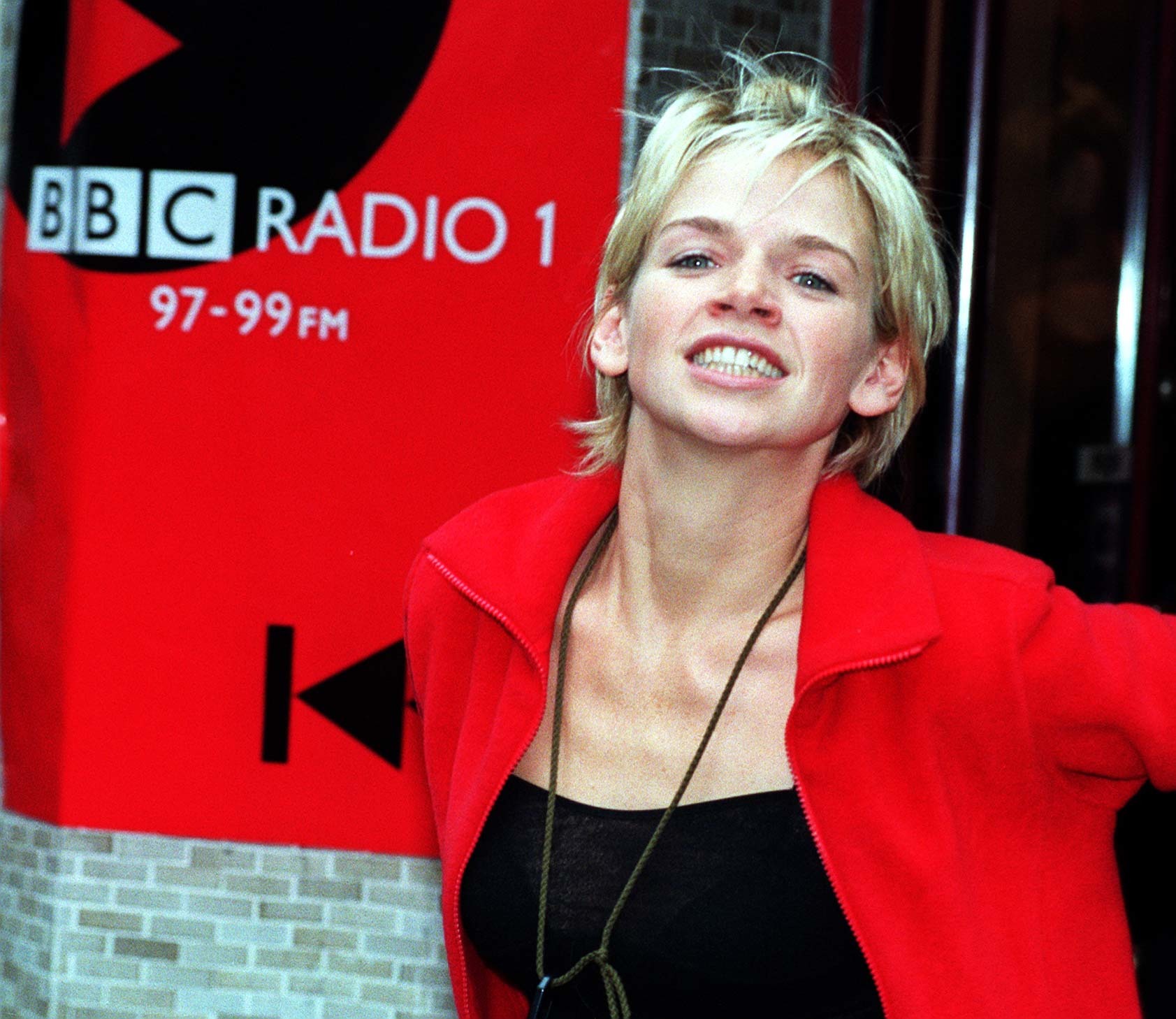 Zoe Ball in front of Radio 1 sign