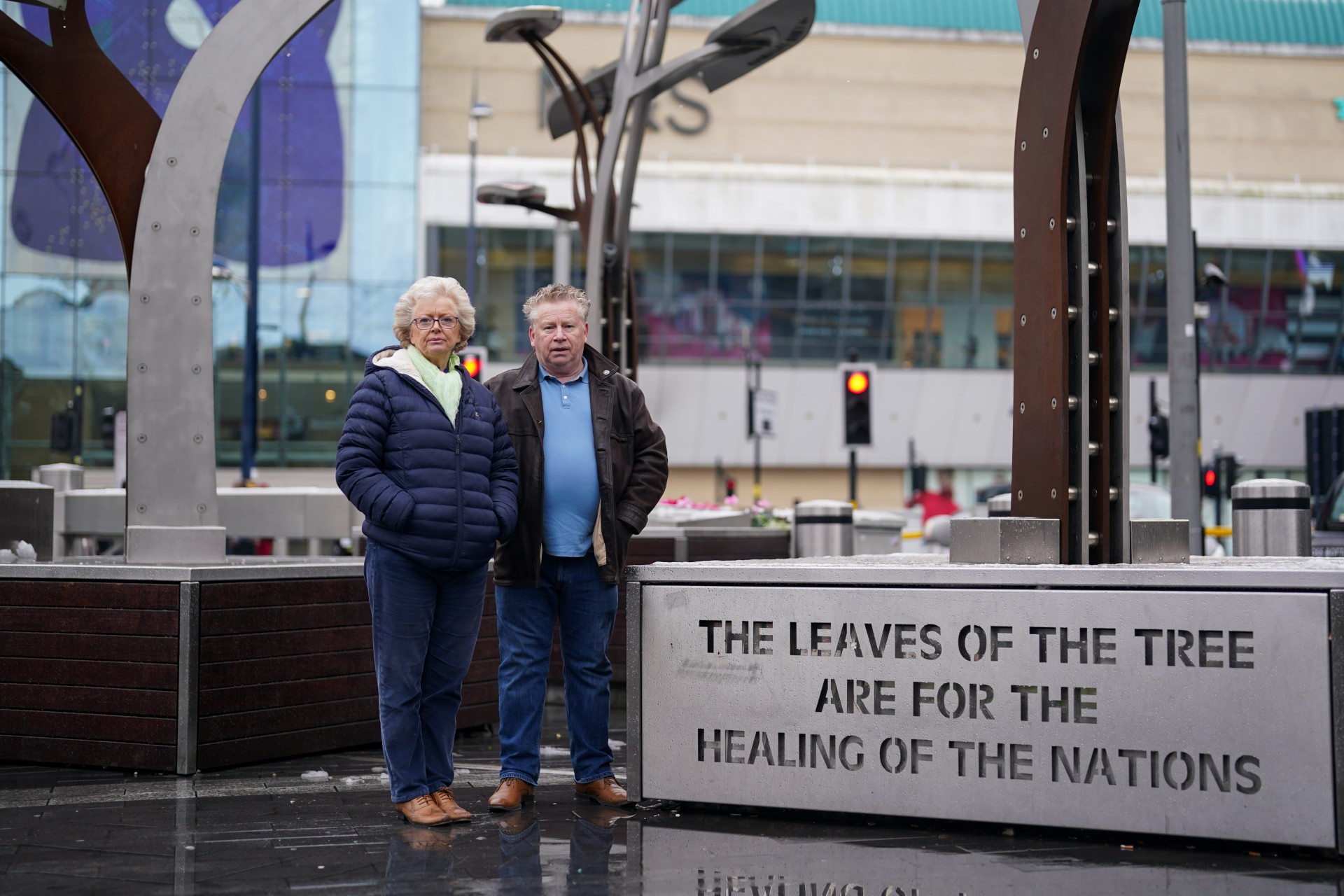 Julie and Brian Hambleton stand by a memorial to the victims