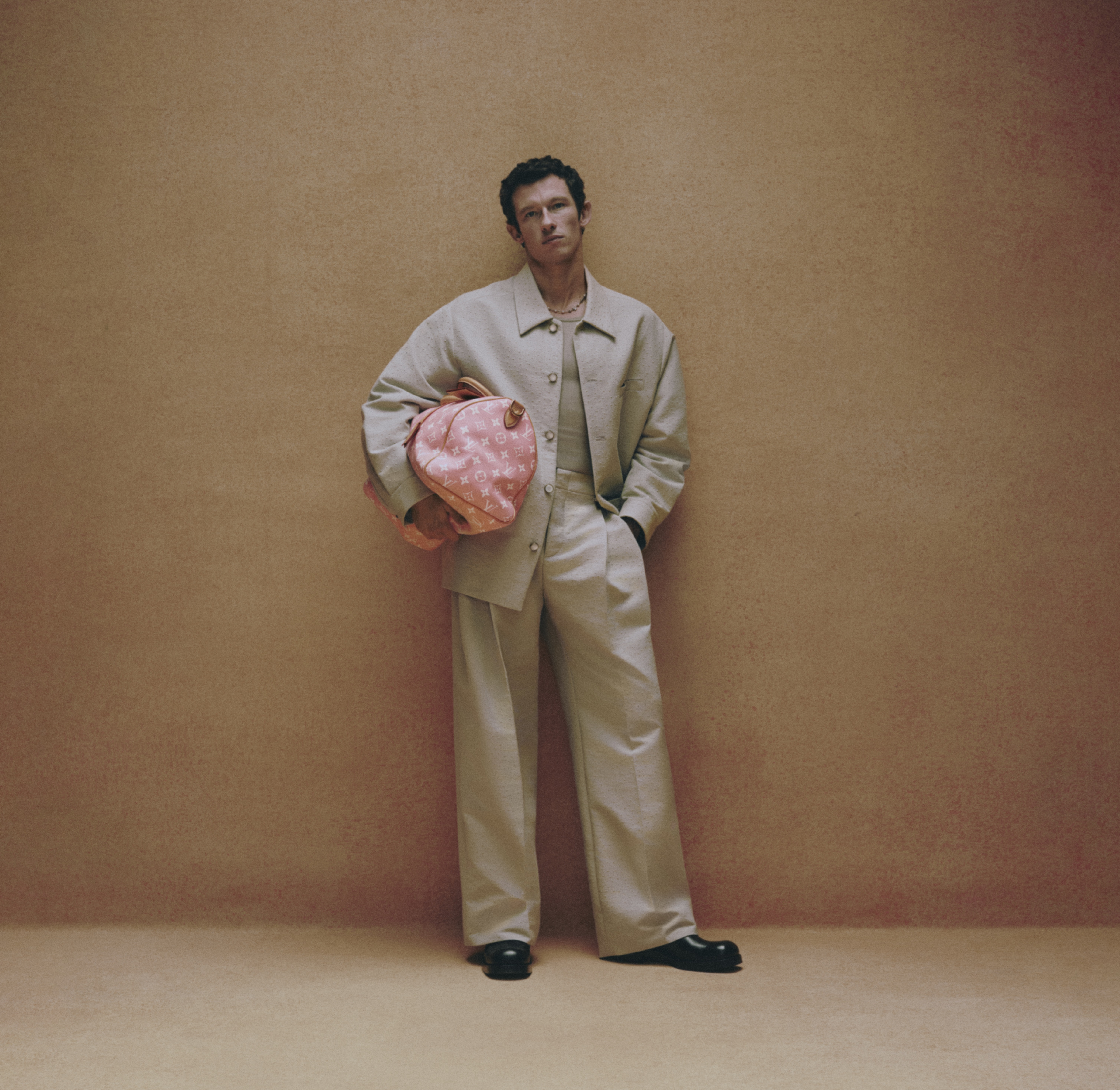 Turner stands holding pink LV bag