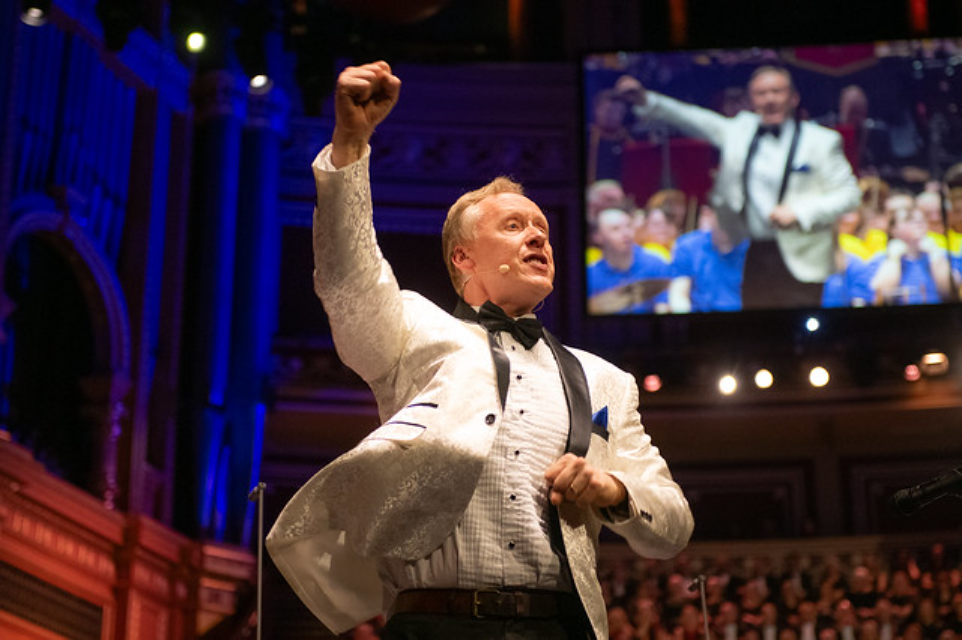 Musician David Stanley raising his fist on stage