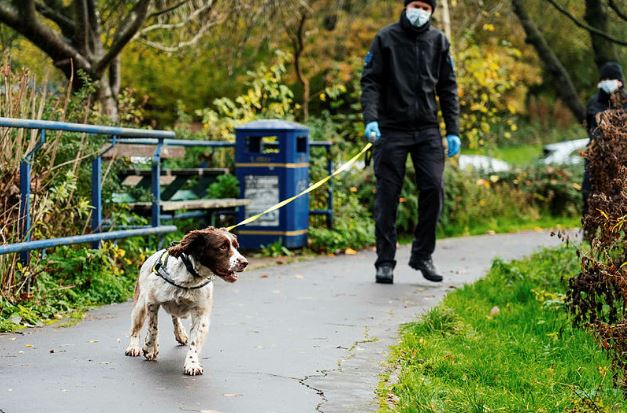 Police dog and handler searching Corby Boating Lake