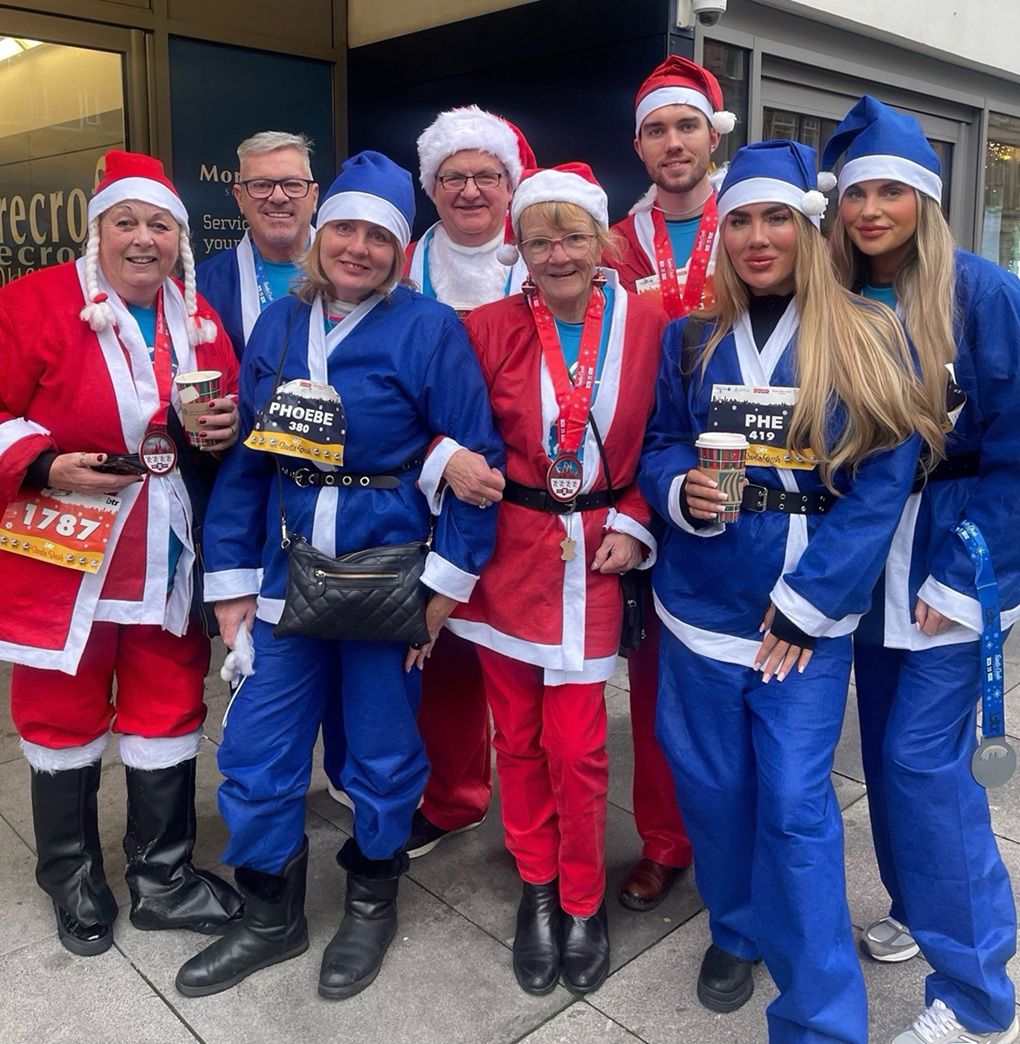 Group of people dressed in Santa outfits