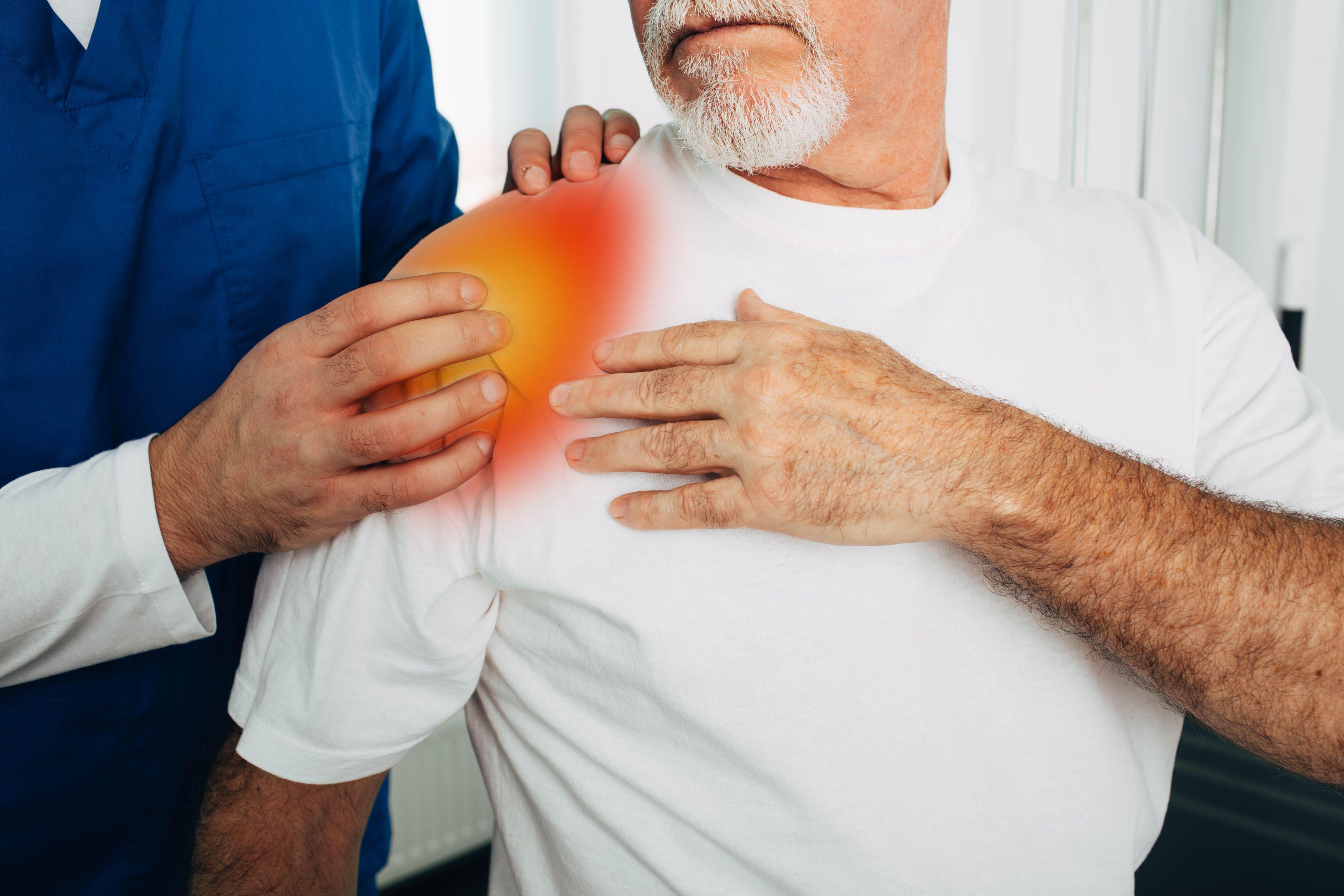 An old man experiencing pain in the shoulder 