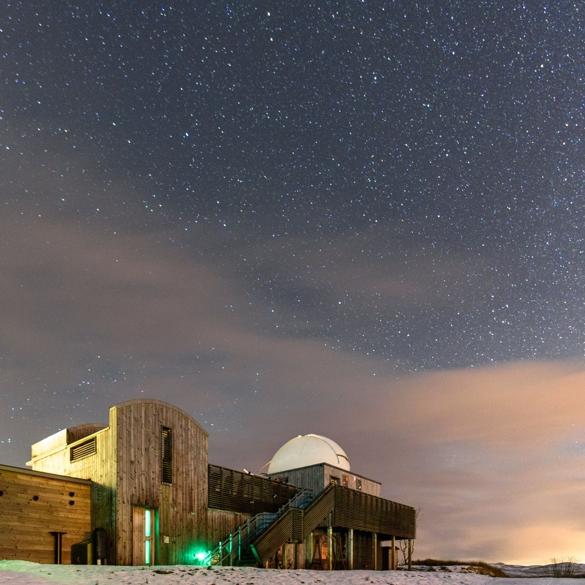 Dramatic picture of observatory against a night sky full of stars