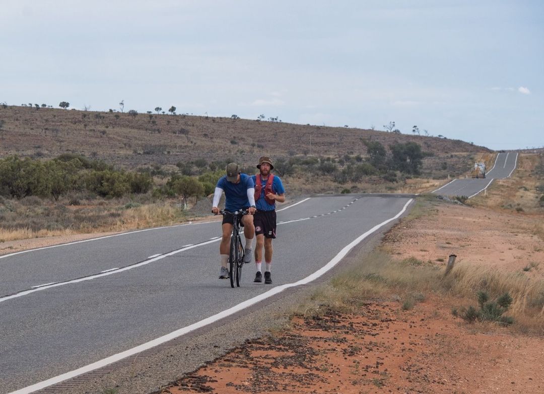 A man running and another cycling