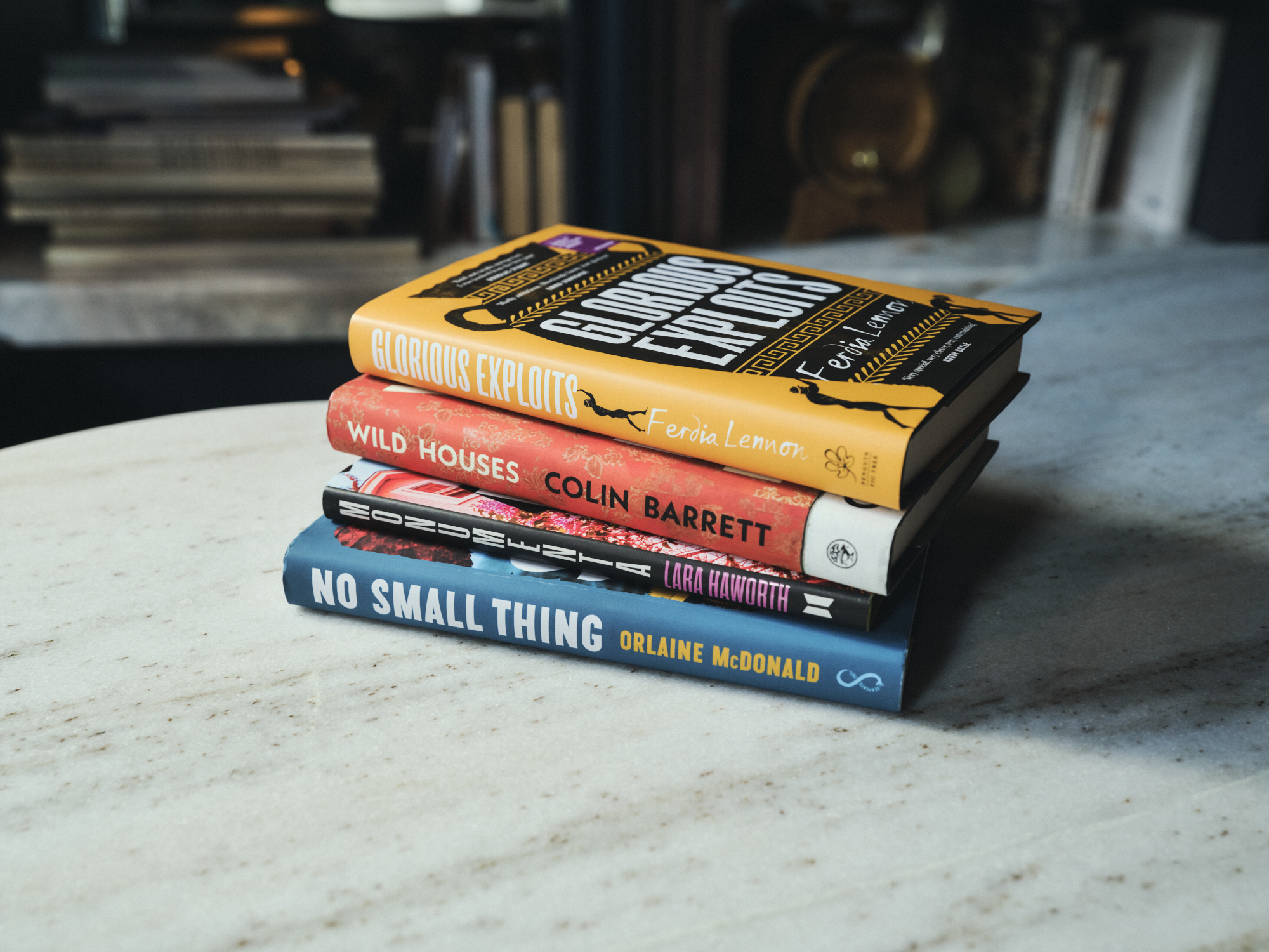 Four books on top of each other on a table