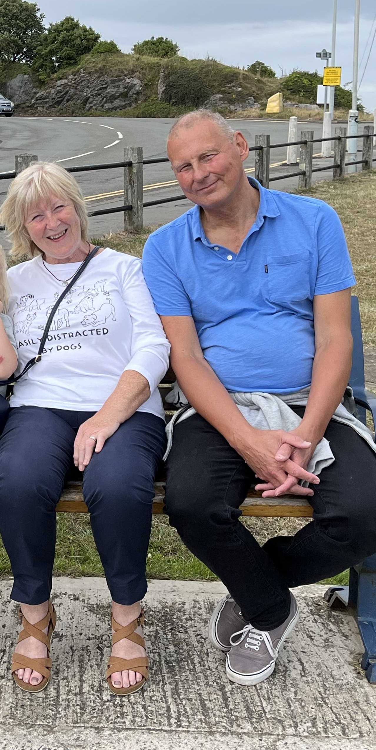 Greg Hutton sitting on a bench with his wife