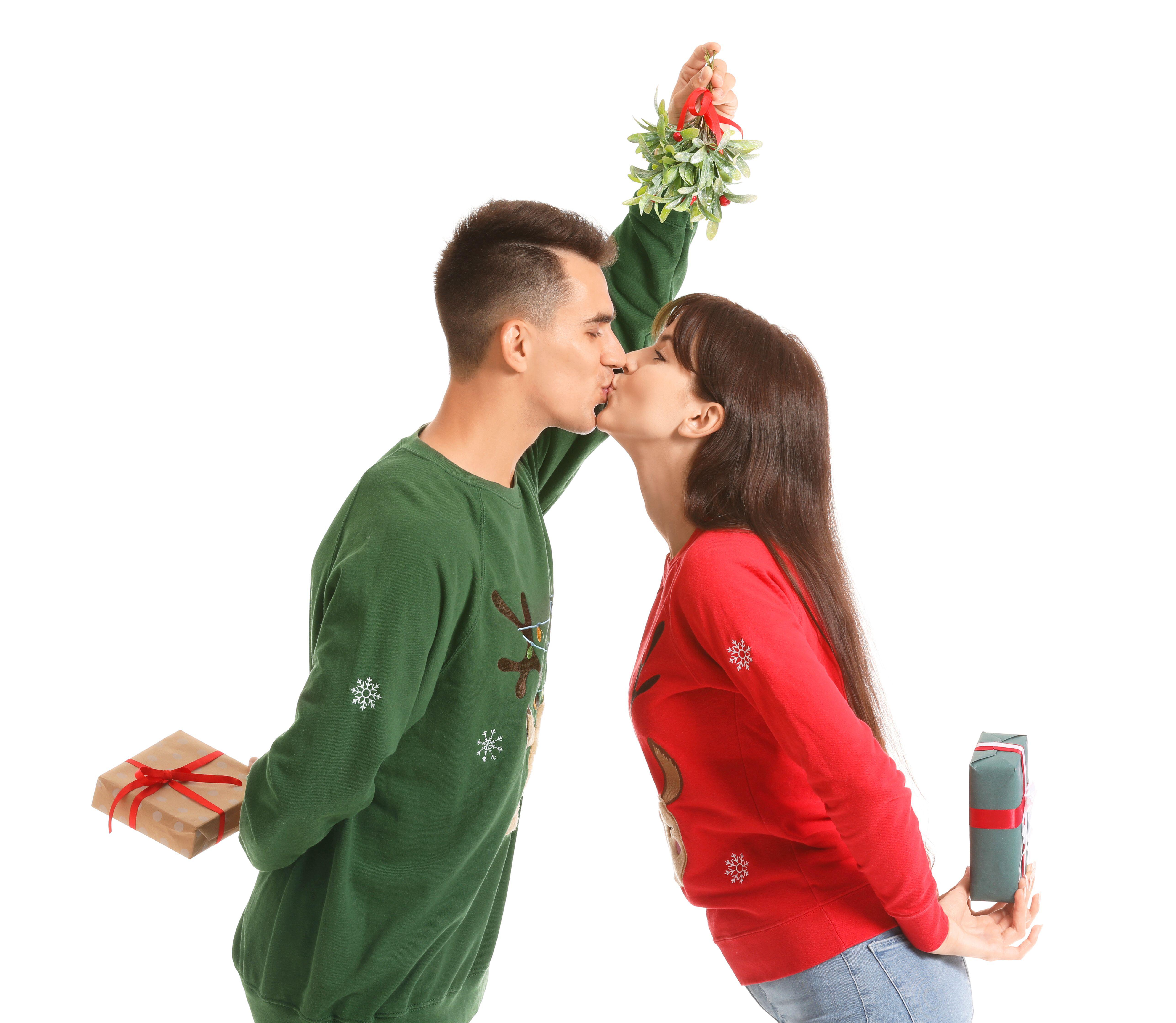 A couple kissing under the mistletoe (Alamy/PA)