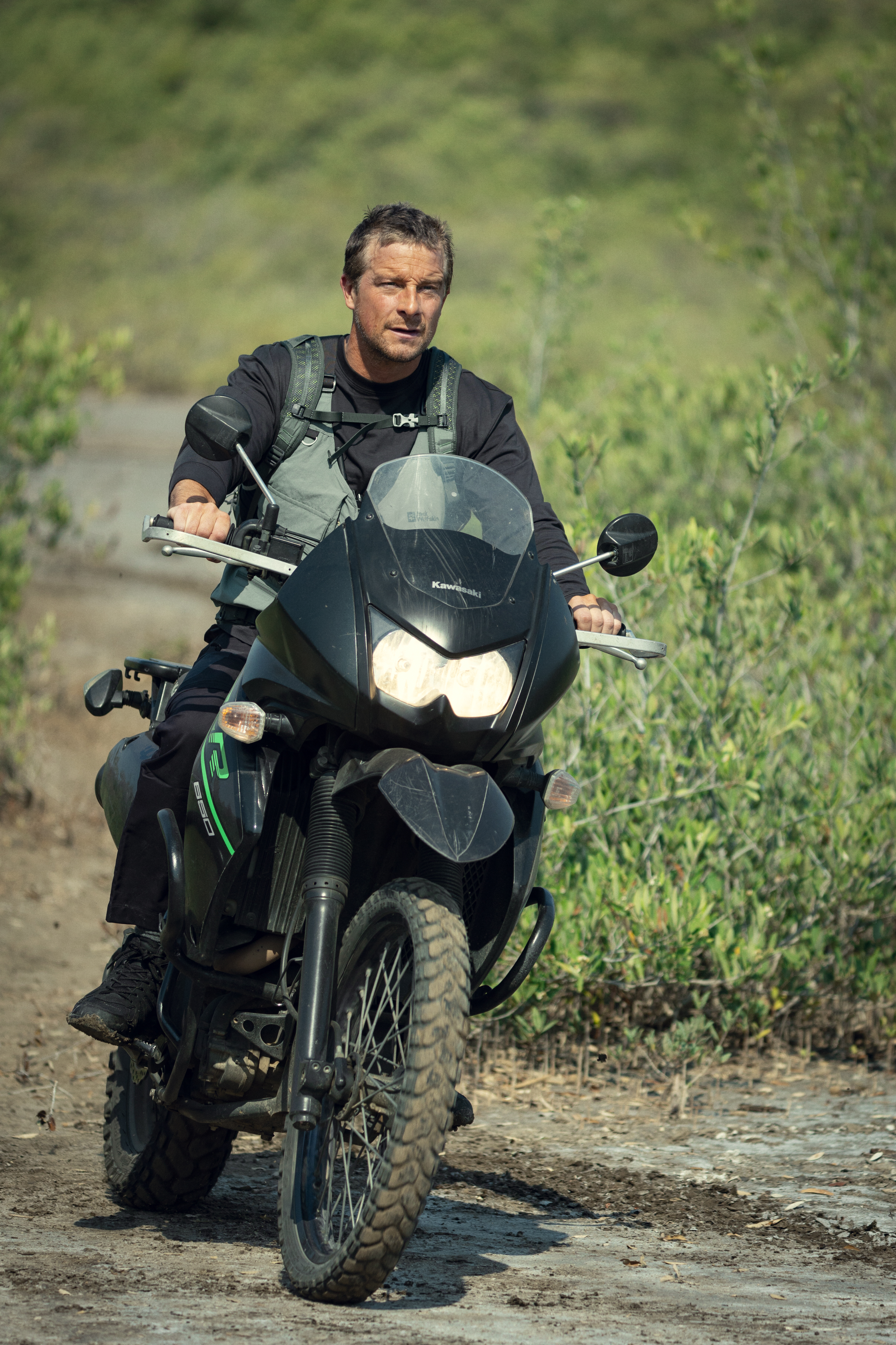 Bear Grylls on a motorbike. (Tom Dymond/Netflix)