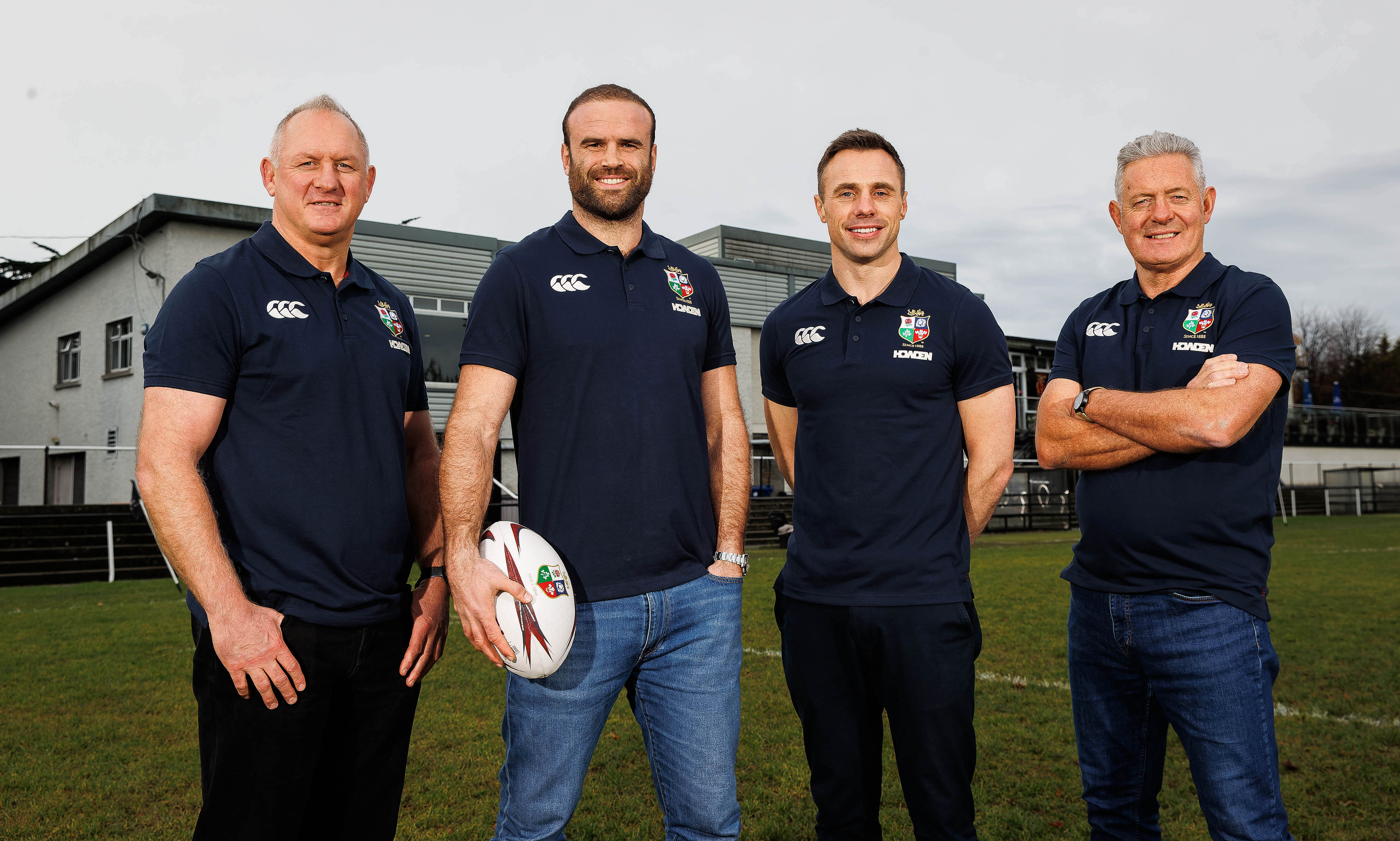 Richard Hill, Jamie Roberts, Tommy Bowe, and Gavin Hastings back the partnership between My Name'5 Doddie Foundation and Gavin Hastings standing in a row on a rugby pitch