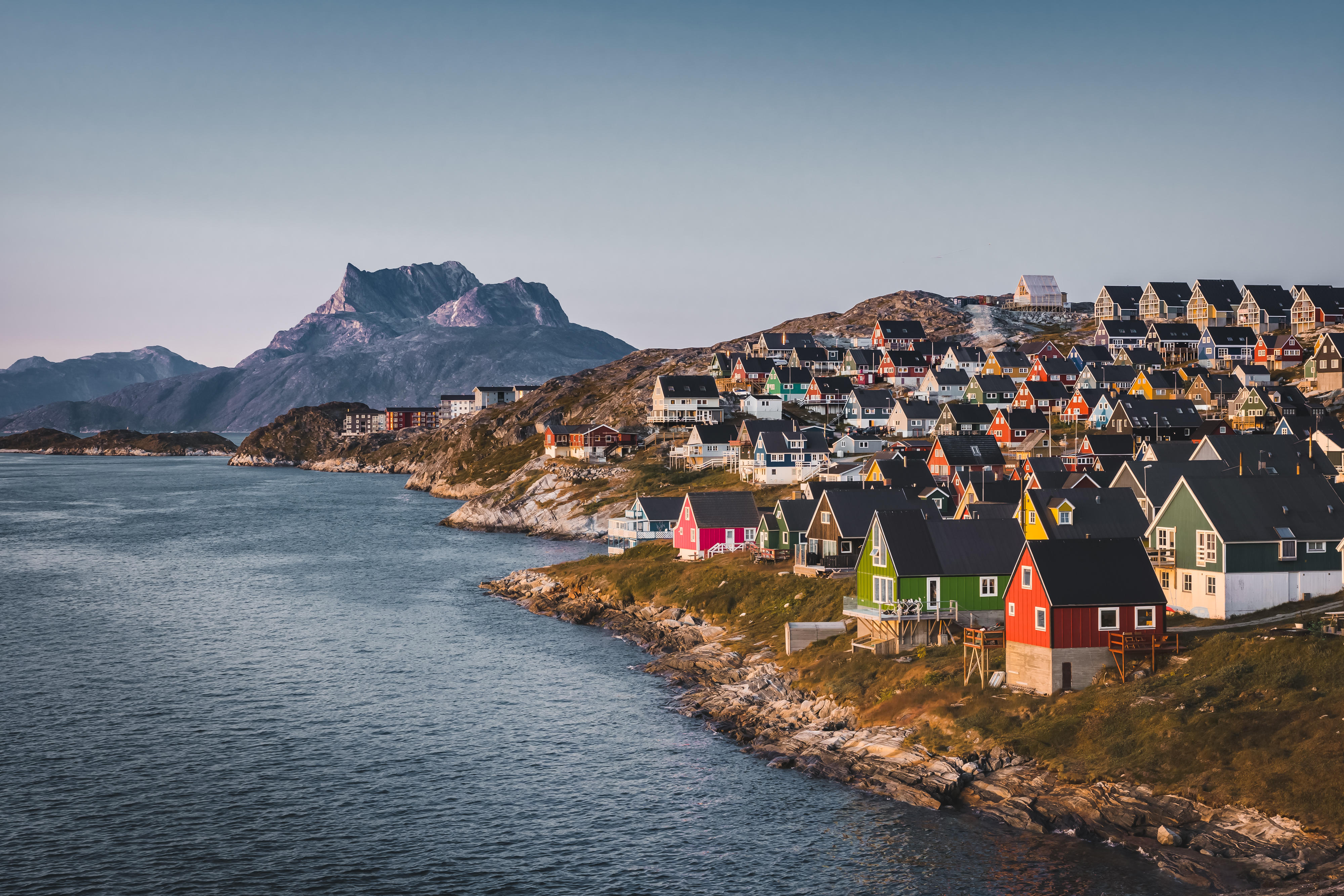 Nuuk capital of Greenland with Beautiful small colorful houses in myggedalen during Sunset Sunrise Midnight Sun. Sermitsiaq Mountain in Background