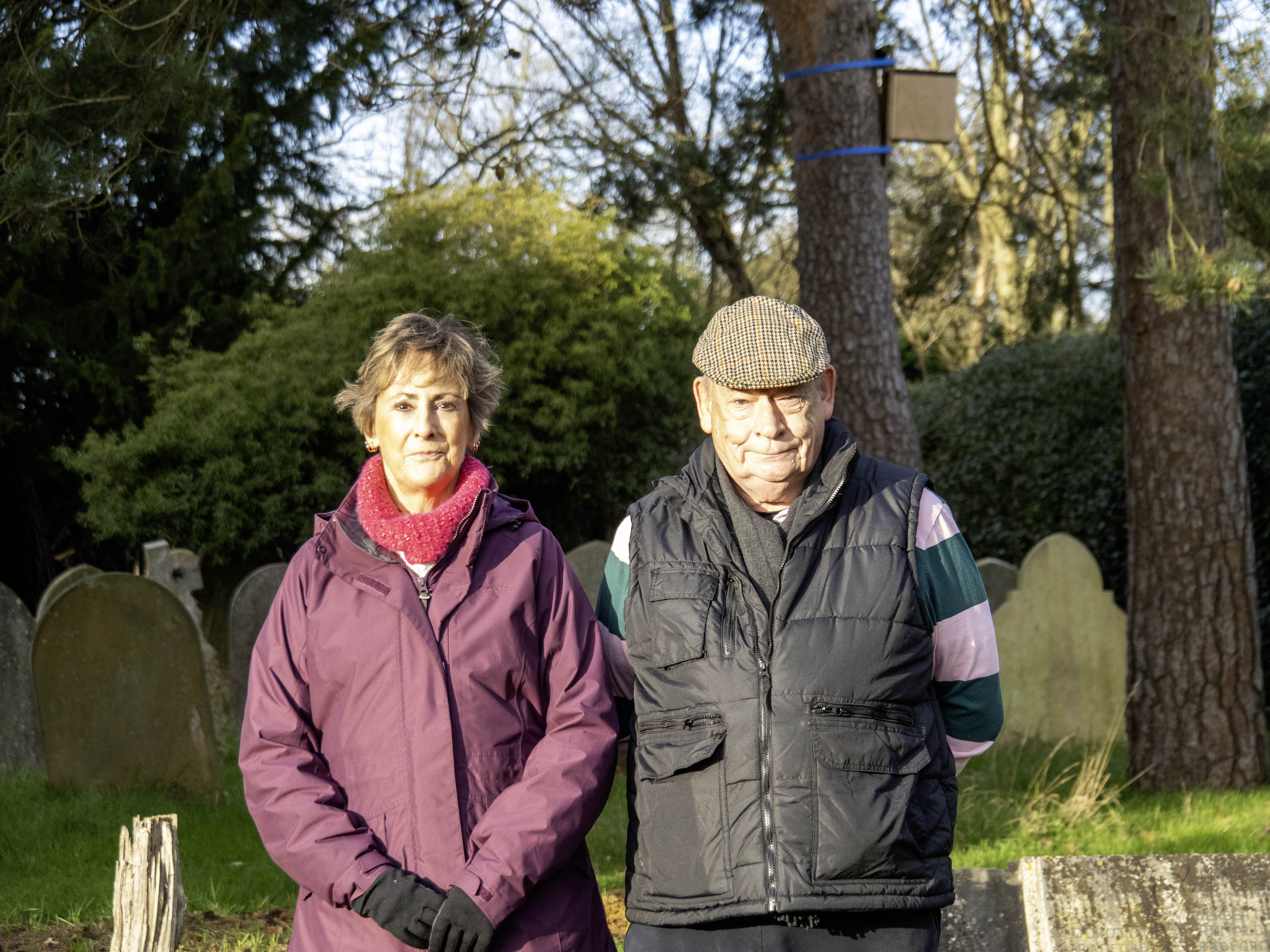 Chris Whitfield (right) and his wife Diane (left) standing in a cemetery