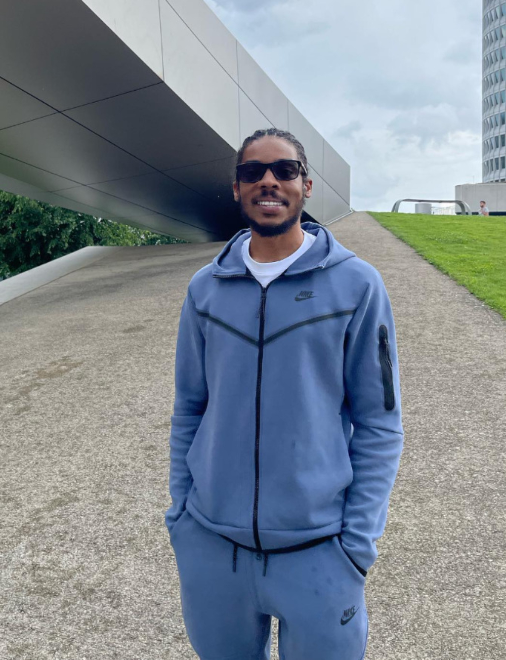 Manny Wallace, known as Big Manny on TikTok, wearing sunglasses and a blue tracksuit