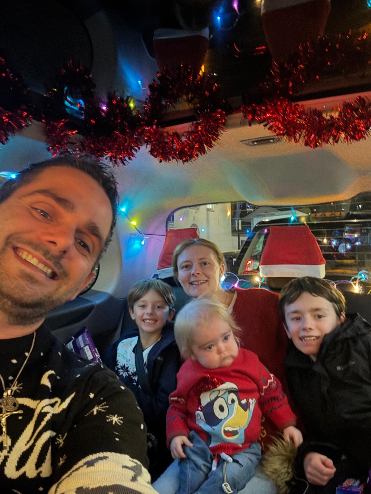 A selfie taken by Alfie's father Chris with Bobby, Kathleen, Alfie and Teddie sat in the black cab behind him