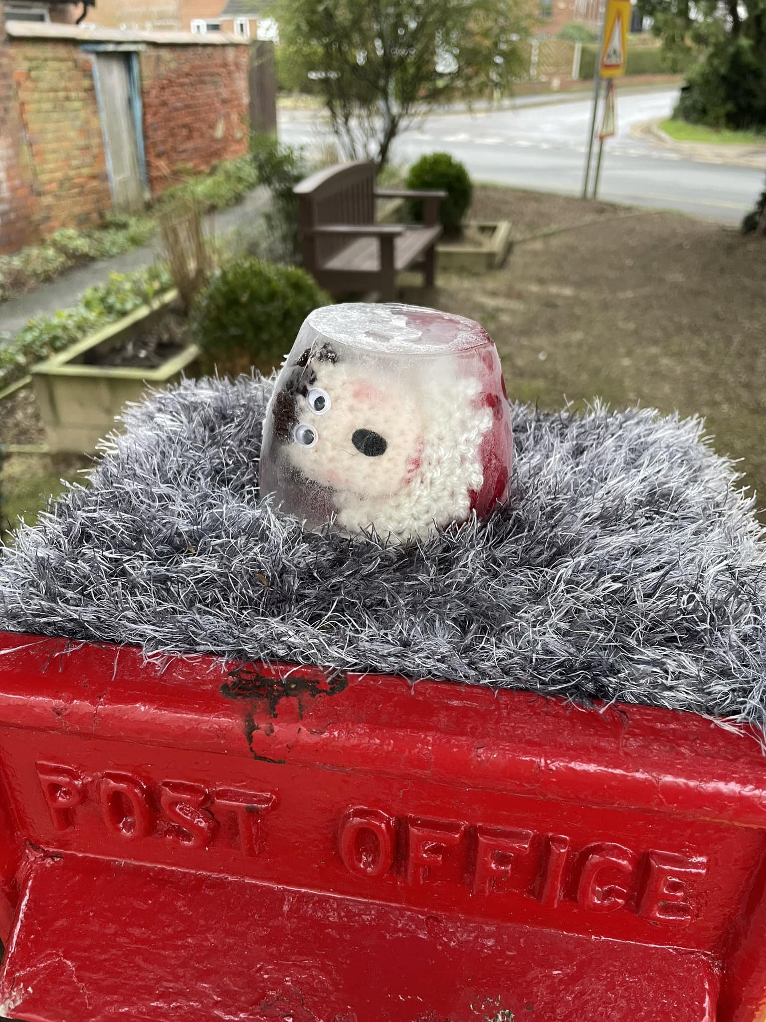 Crocheted elf in container 