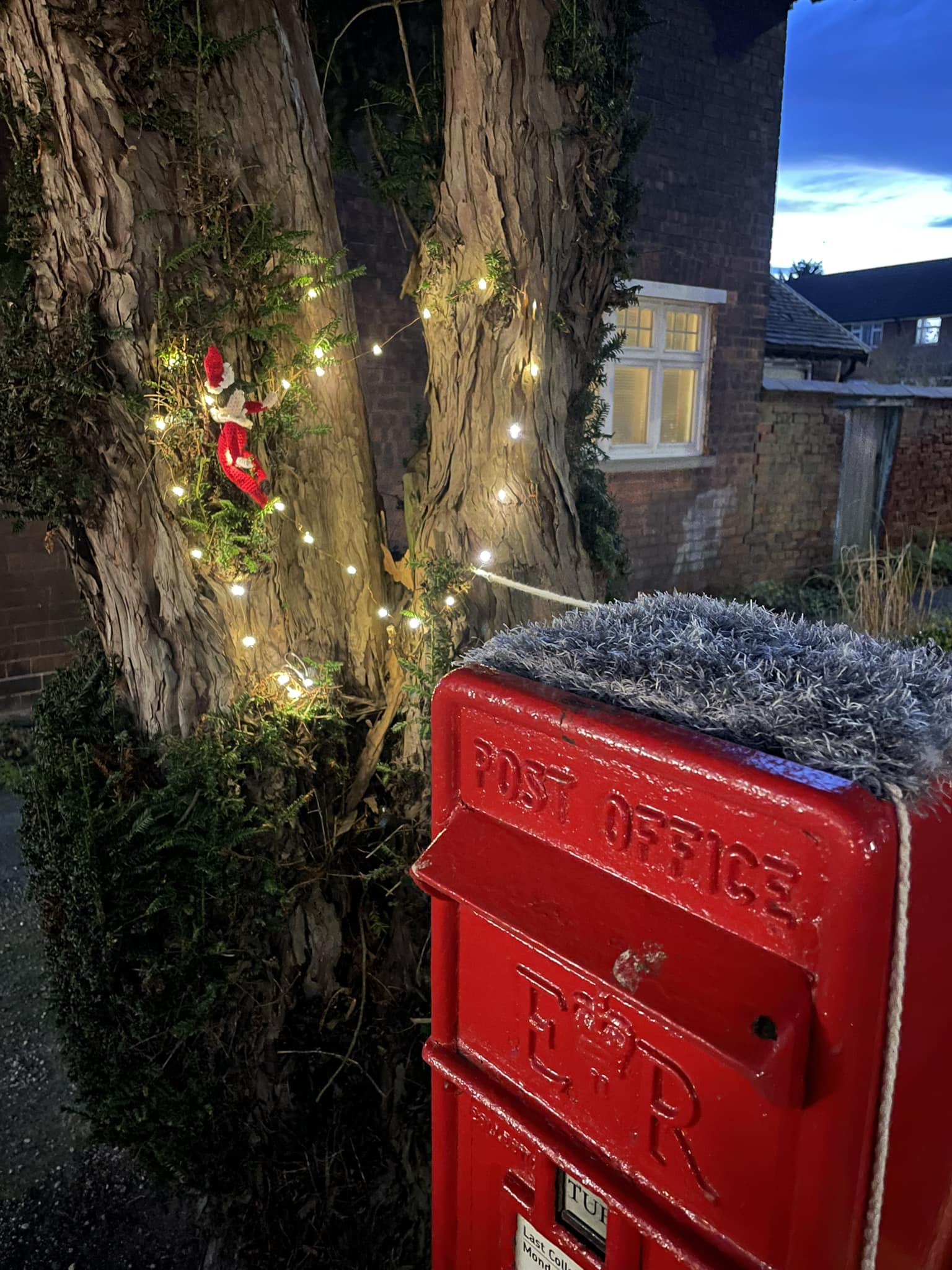 Elf decorating tree with lights 