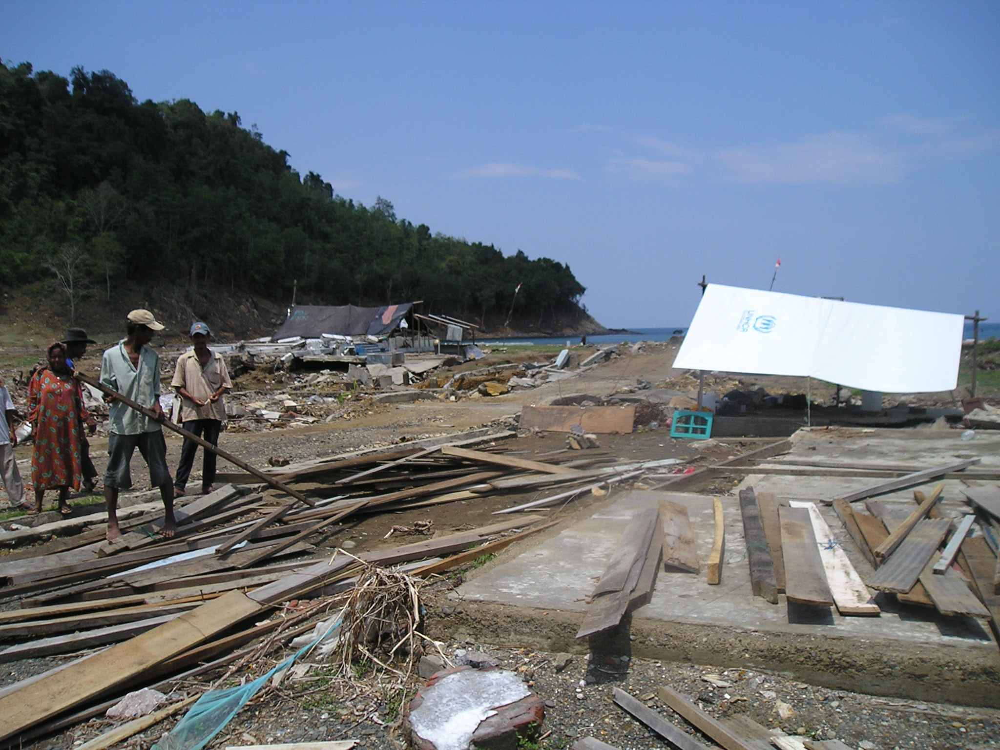 People look at the damage caused by the tsunami