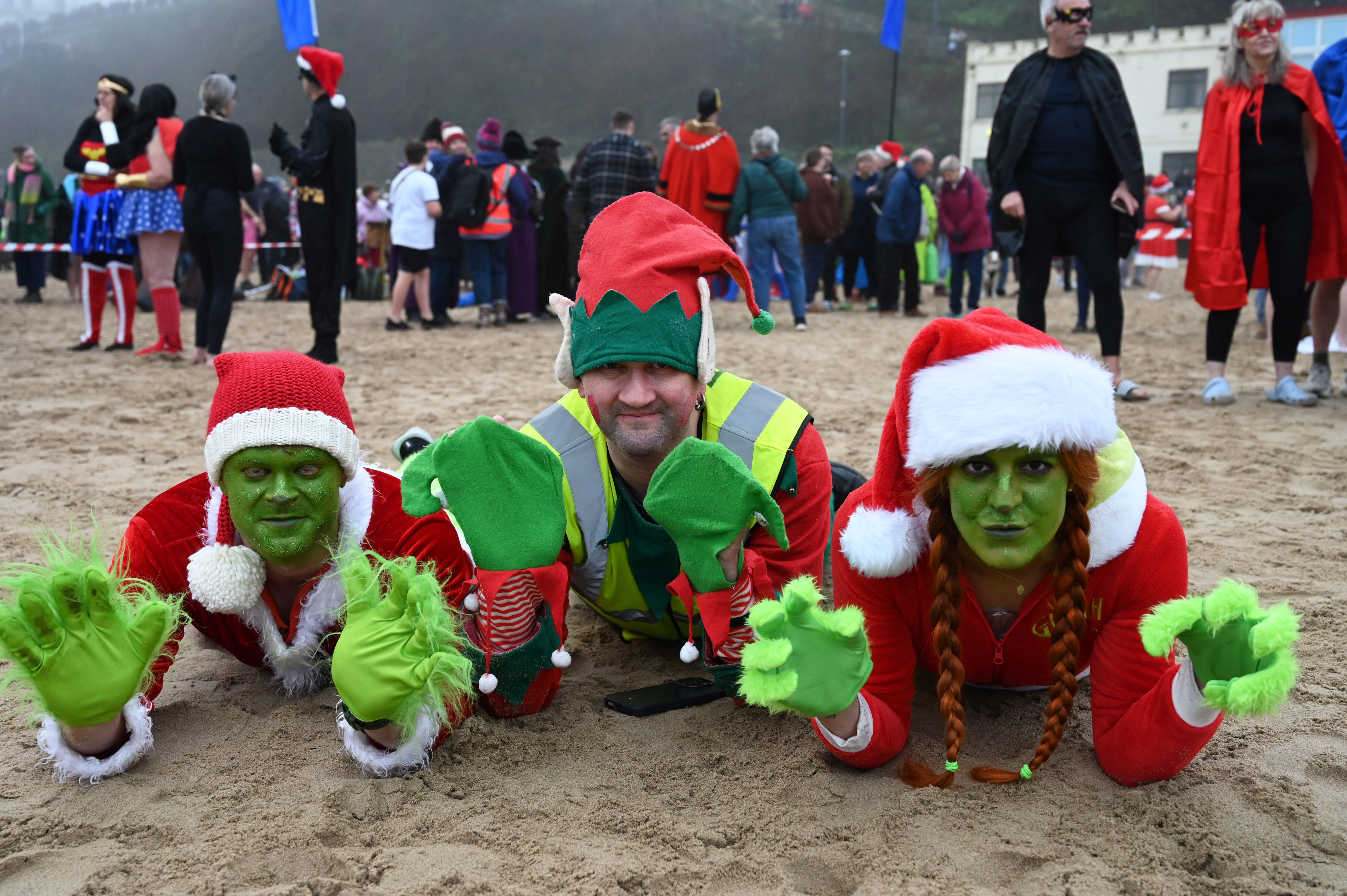 People at the annual Tenby Boxing Day swim dressed as superheroes(Gareth Davies Photography/Tenby Boxing Day Swim/PA)