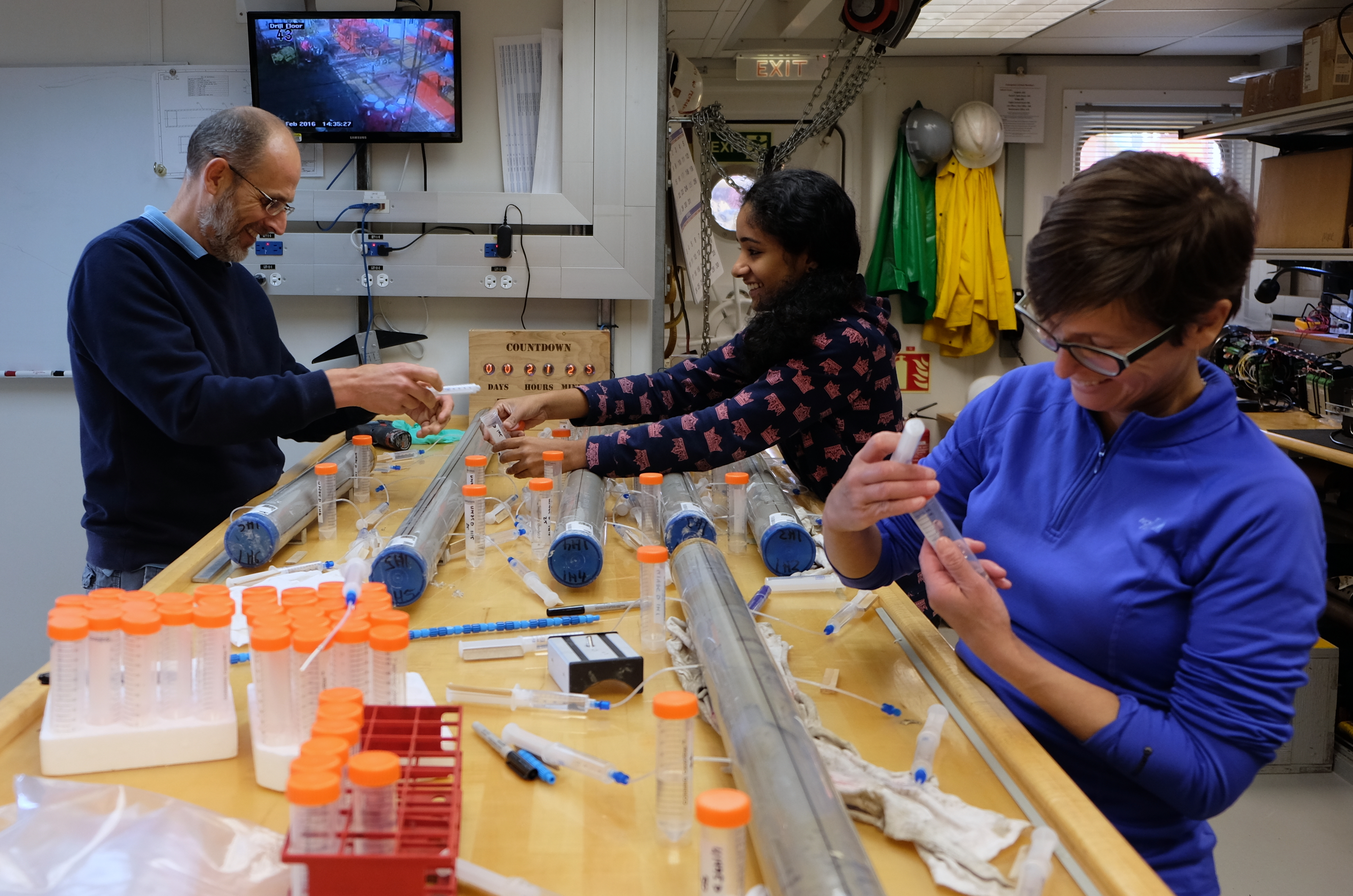 Scientists are photographed taking samples from the core on board a drill ship (Jens Gruetzner/Alfred-Wegener-Institut for Polar and Marine Research/PA)