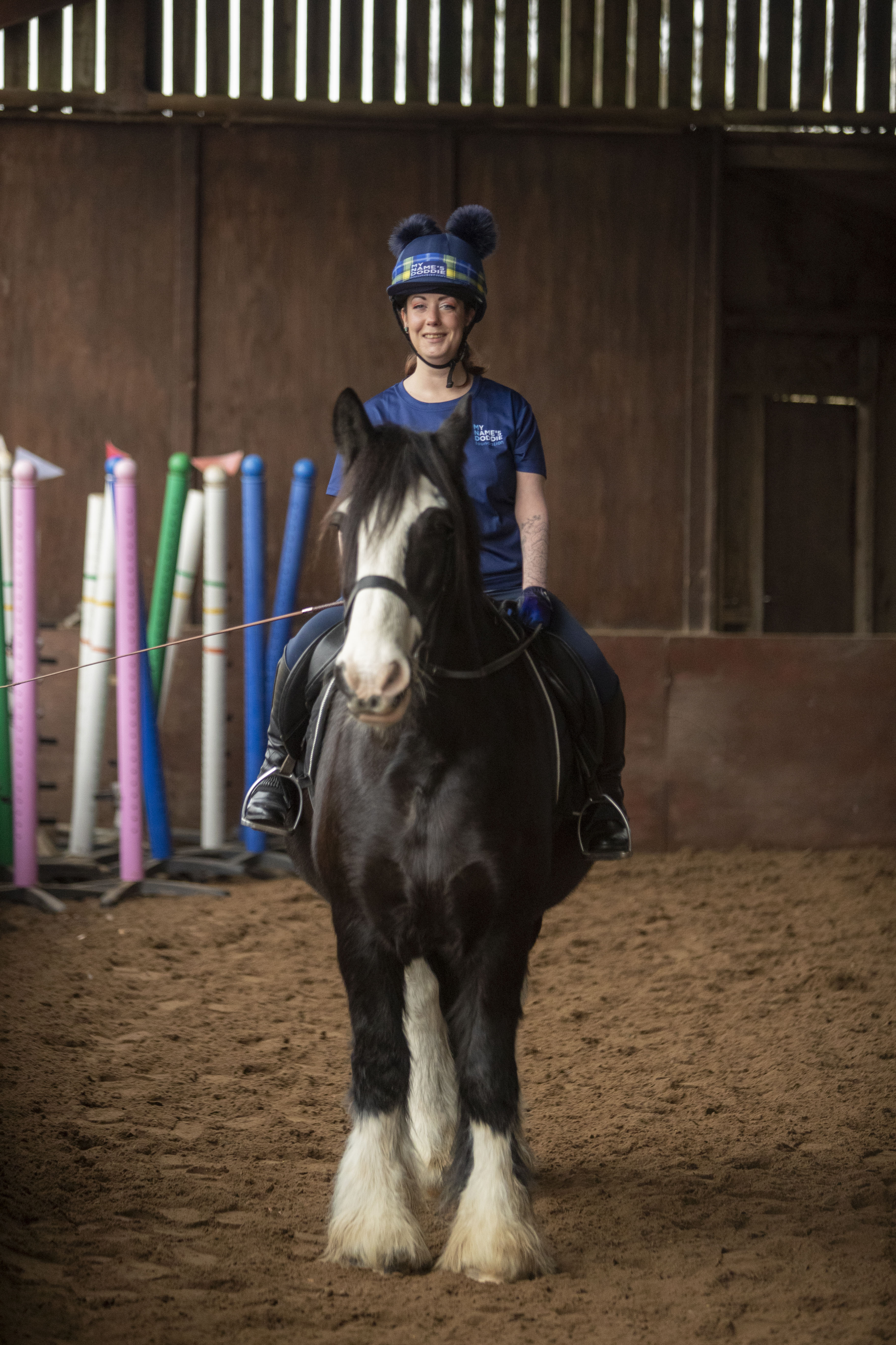 Sheree Gregg smiling while on horseback