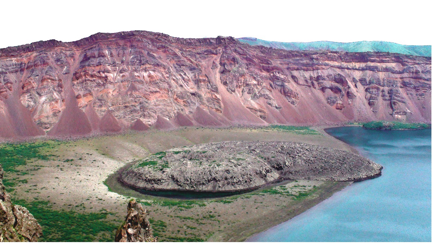 A crater on an island with water to the side 