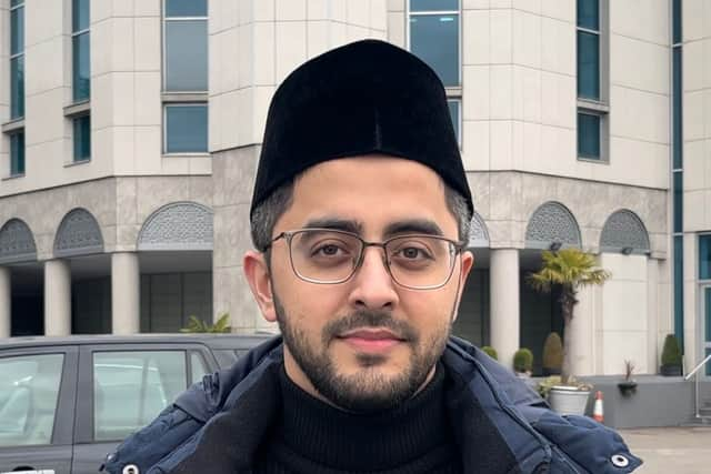 A man standing in front of a mosque