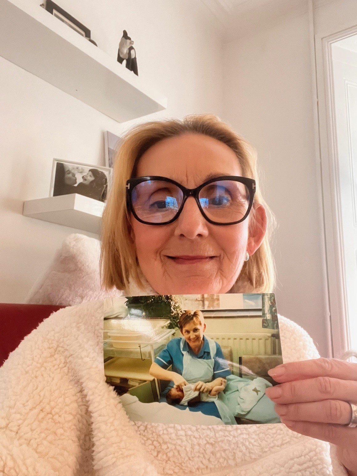 Ms Cooling holding a picture of her with Ms Wintle as a baby