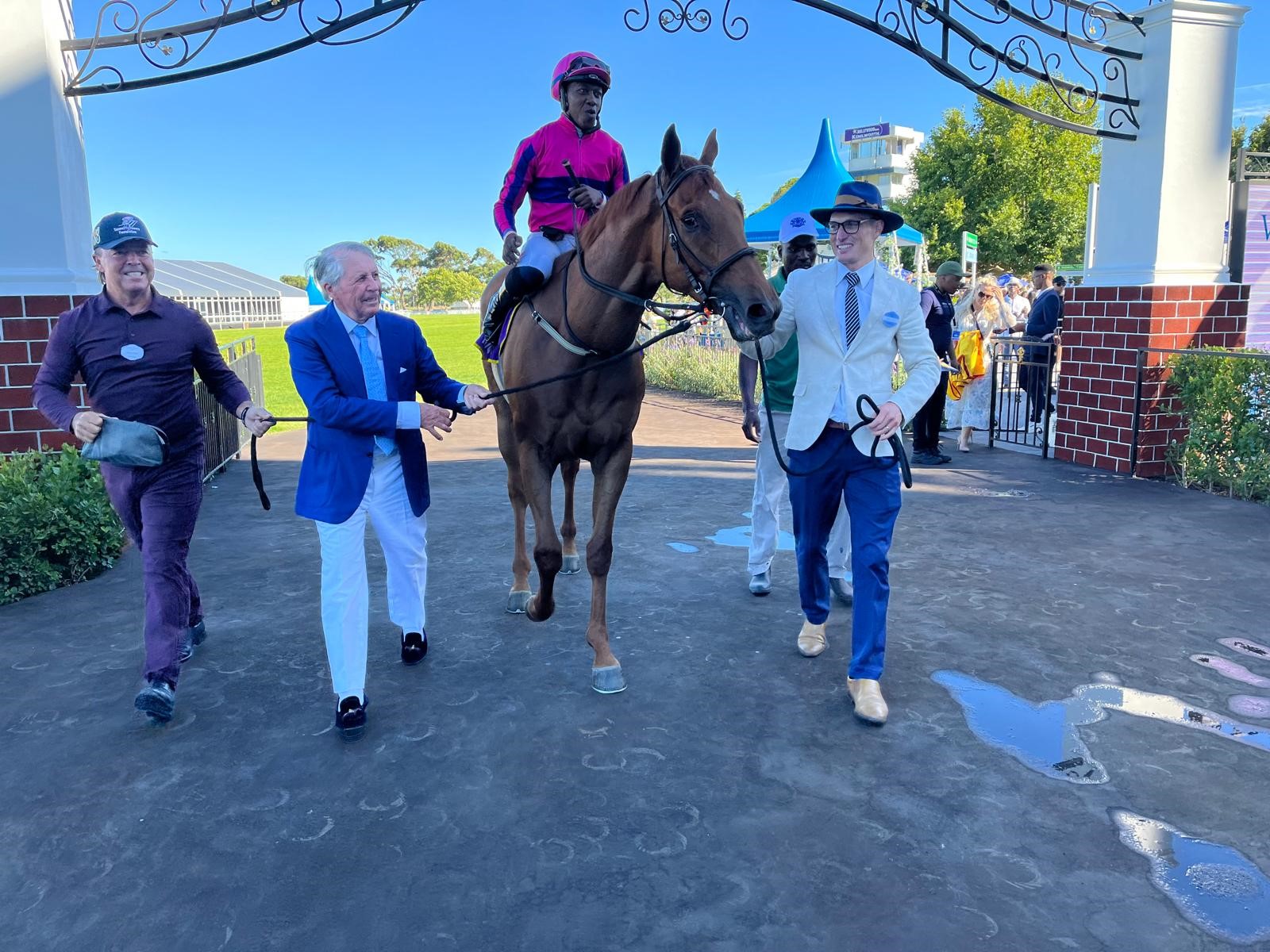 Gary Player leading King Pelles back to the winner's enclosure