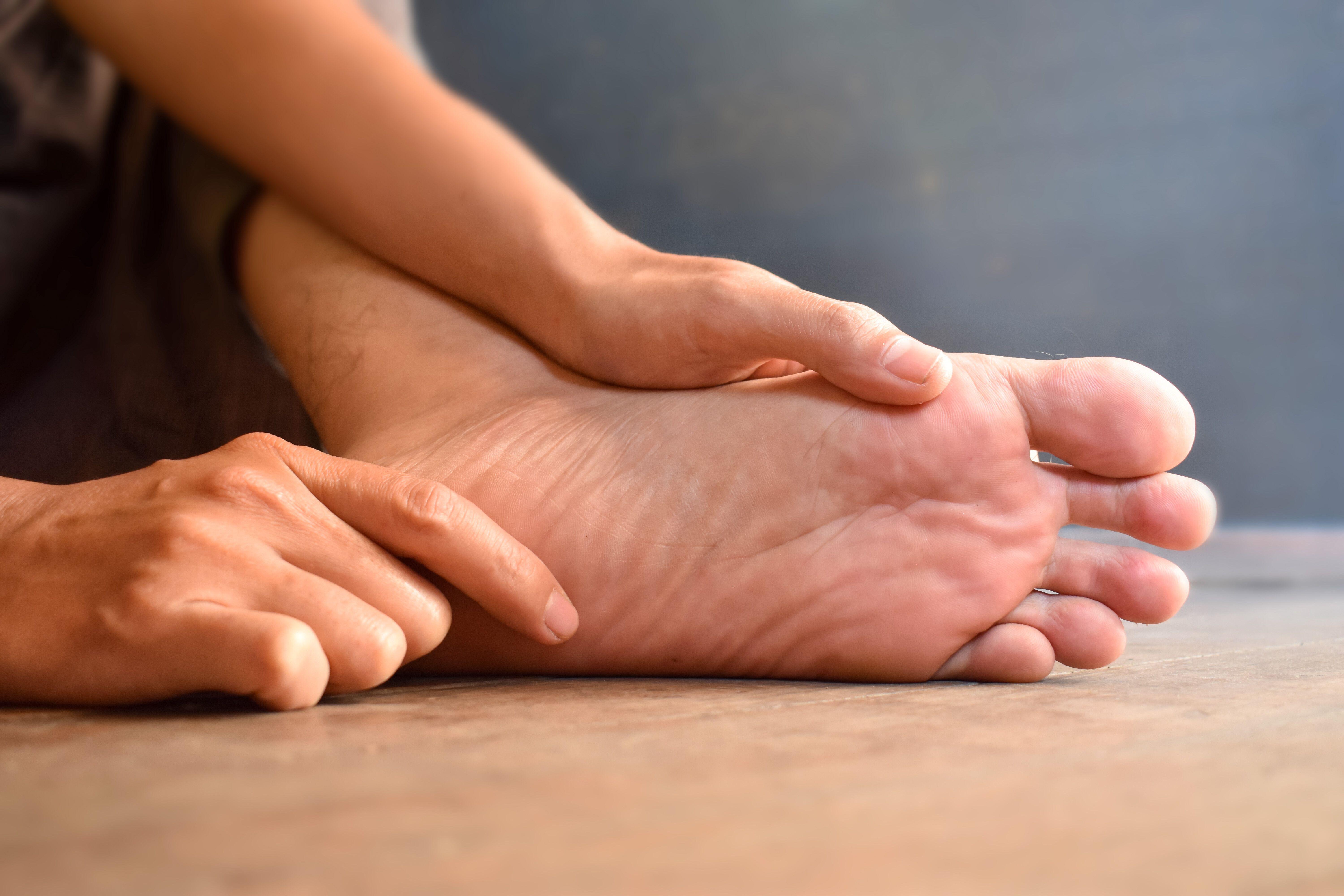 A man holding his feet