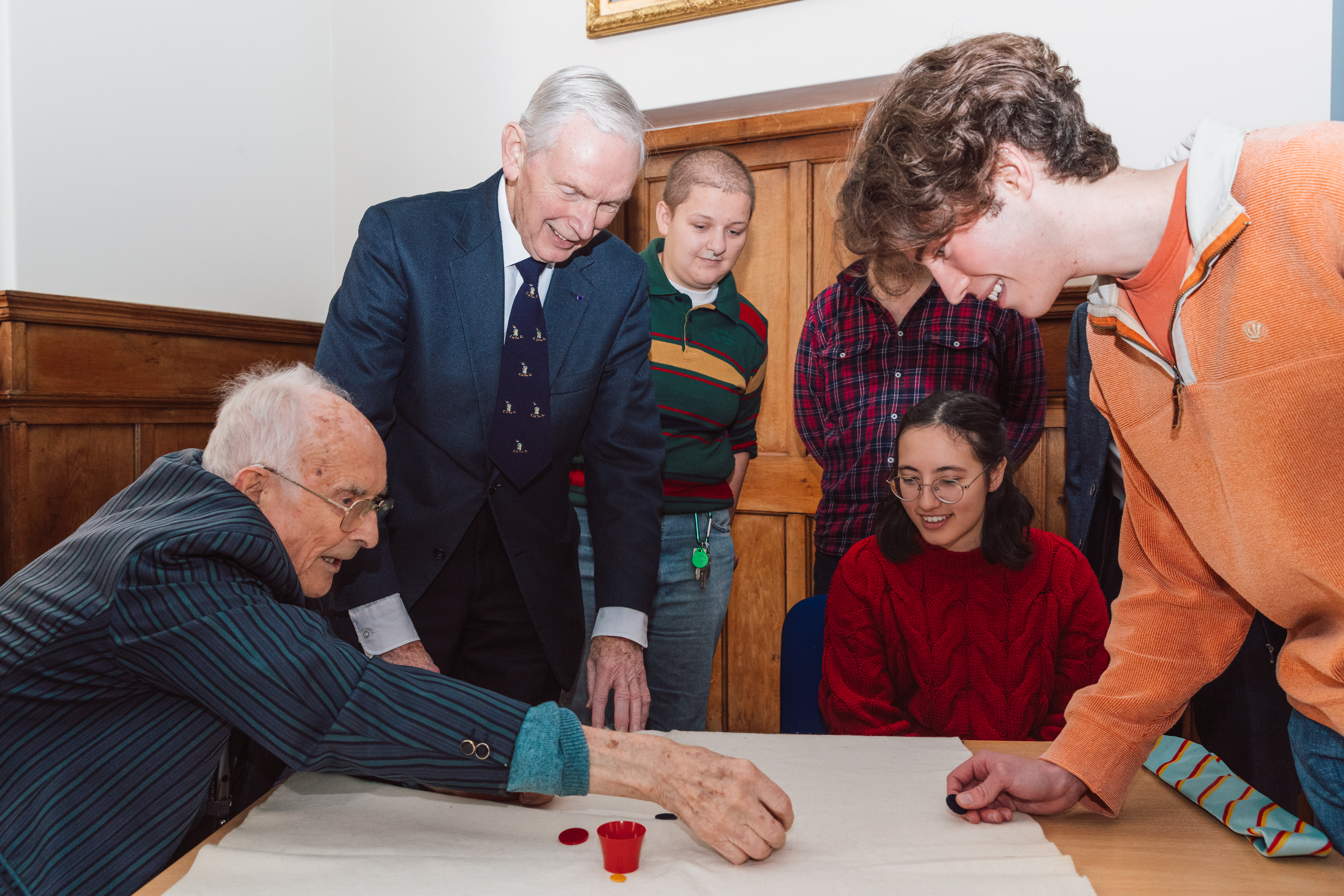 Bill Steen, far left, with Peter Downes, playing tiddlywinks with current Cambridge University staff and students (Cambridge University/ PA)